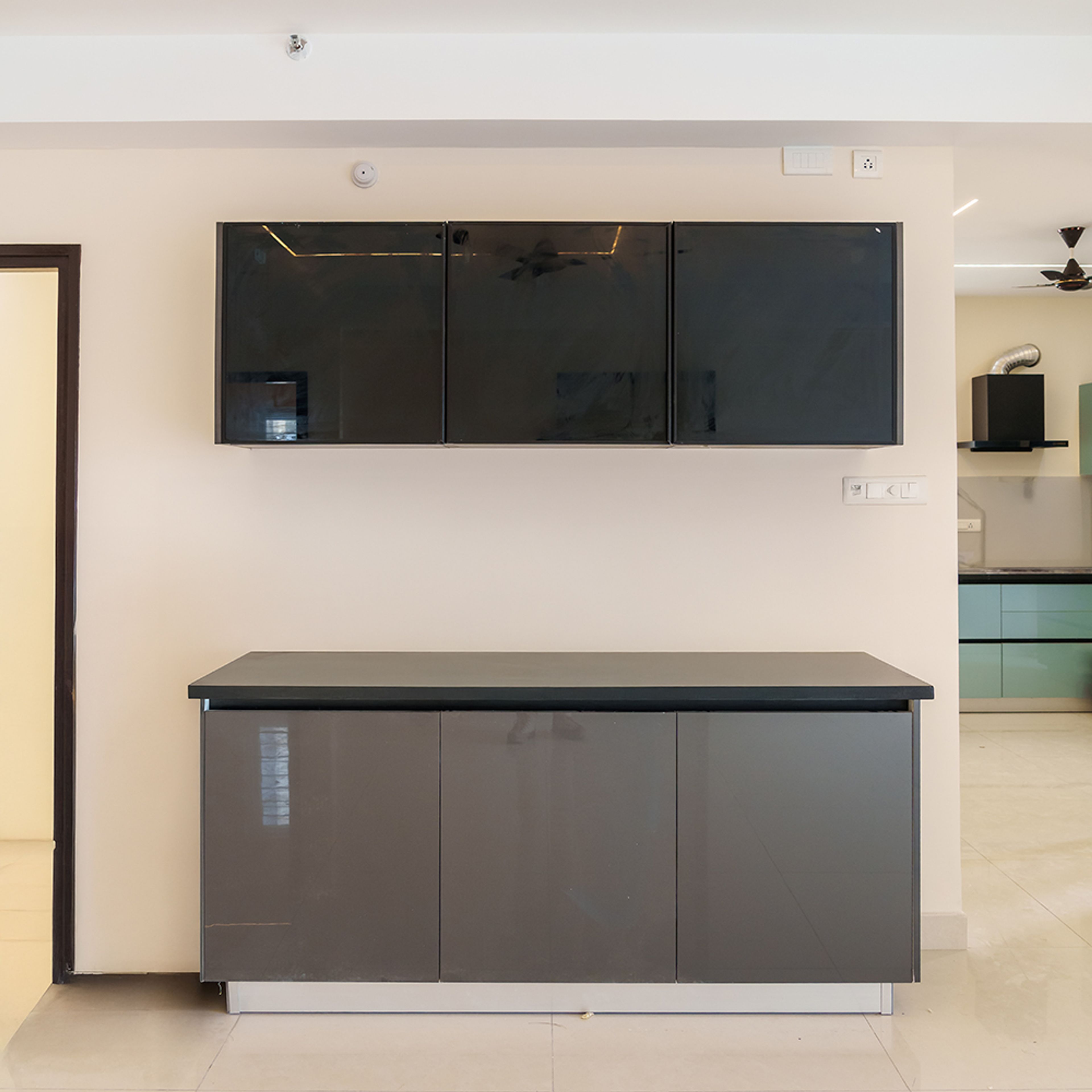 Crockery Unit Design with Dark Grey Base Units, Granite Counter and Black Tinted Glass Wall Units