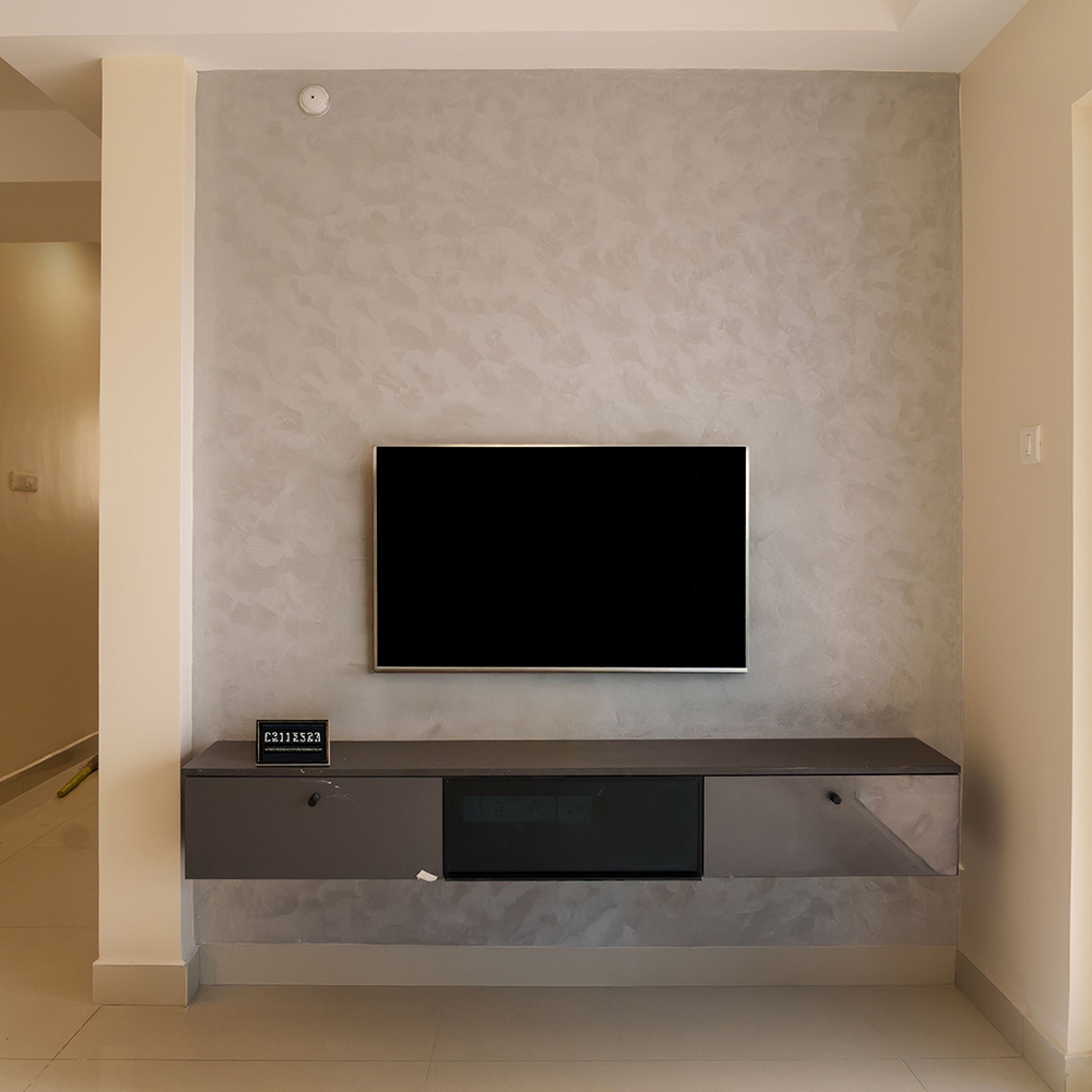 TV Unit Design with Brown Drawers and Beige Textured Wall