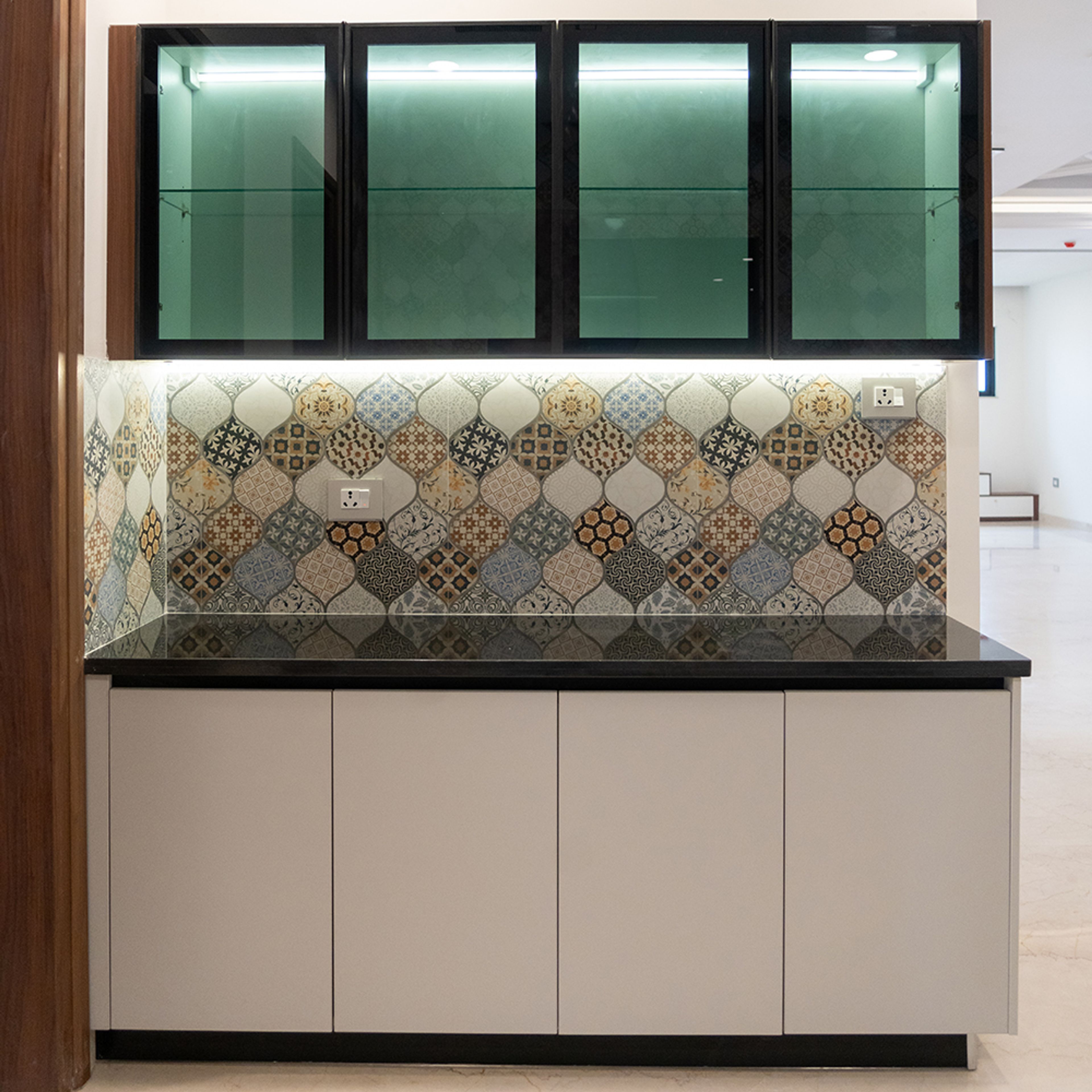 Crockery Unit Design with Beige Cabinets, Glass Shutter Units and Moroccan Tile Backsplash