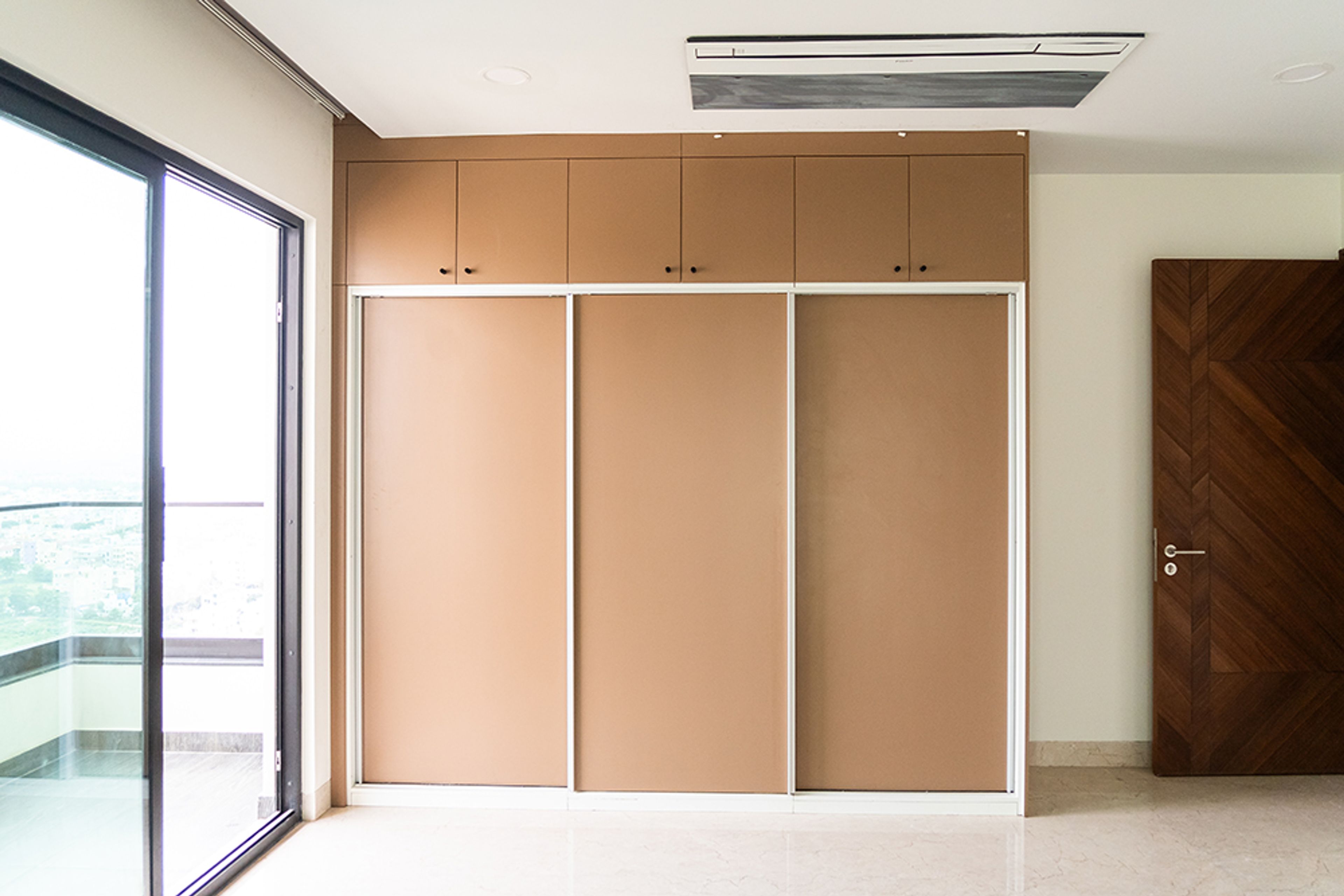 3-Door Brown Sliding  Wardrobe Design with Loft unit
