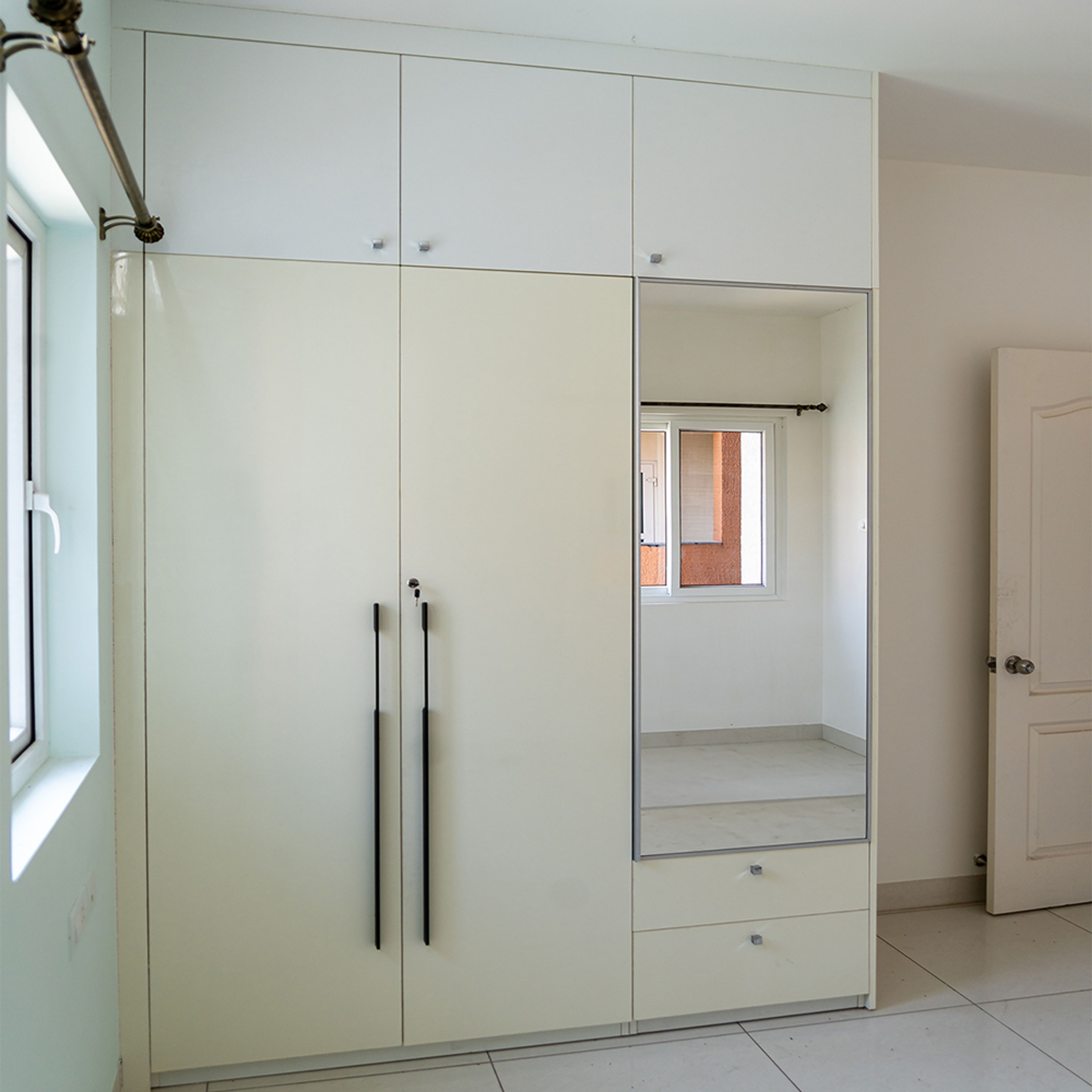 2-door cream swing wardrobe design with integrated mirror
