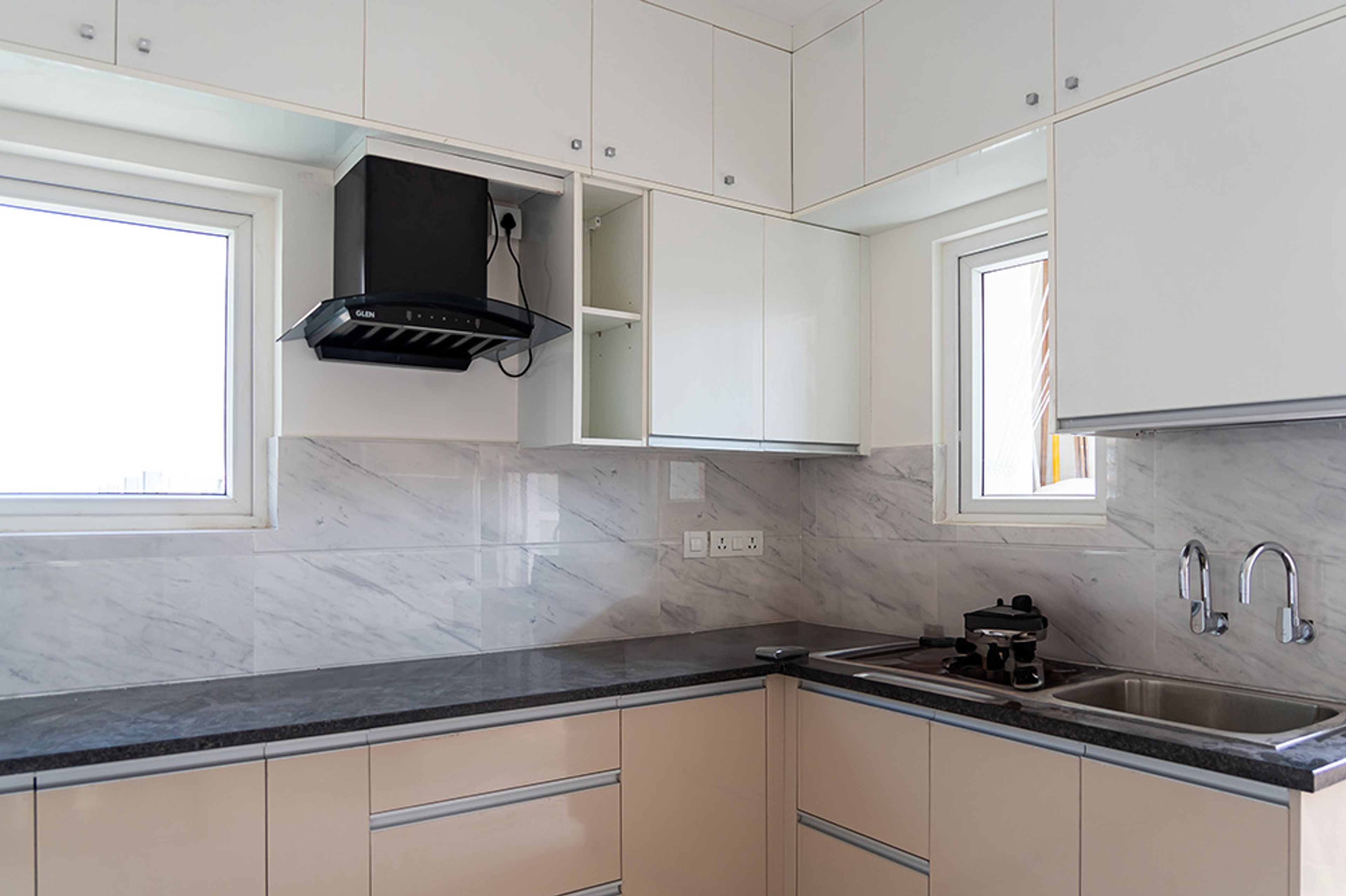 L-shaped kitchen design with peach and white units