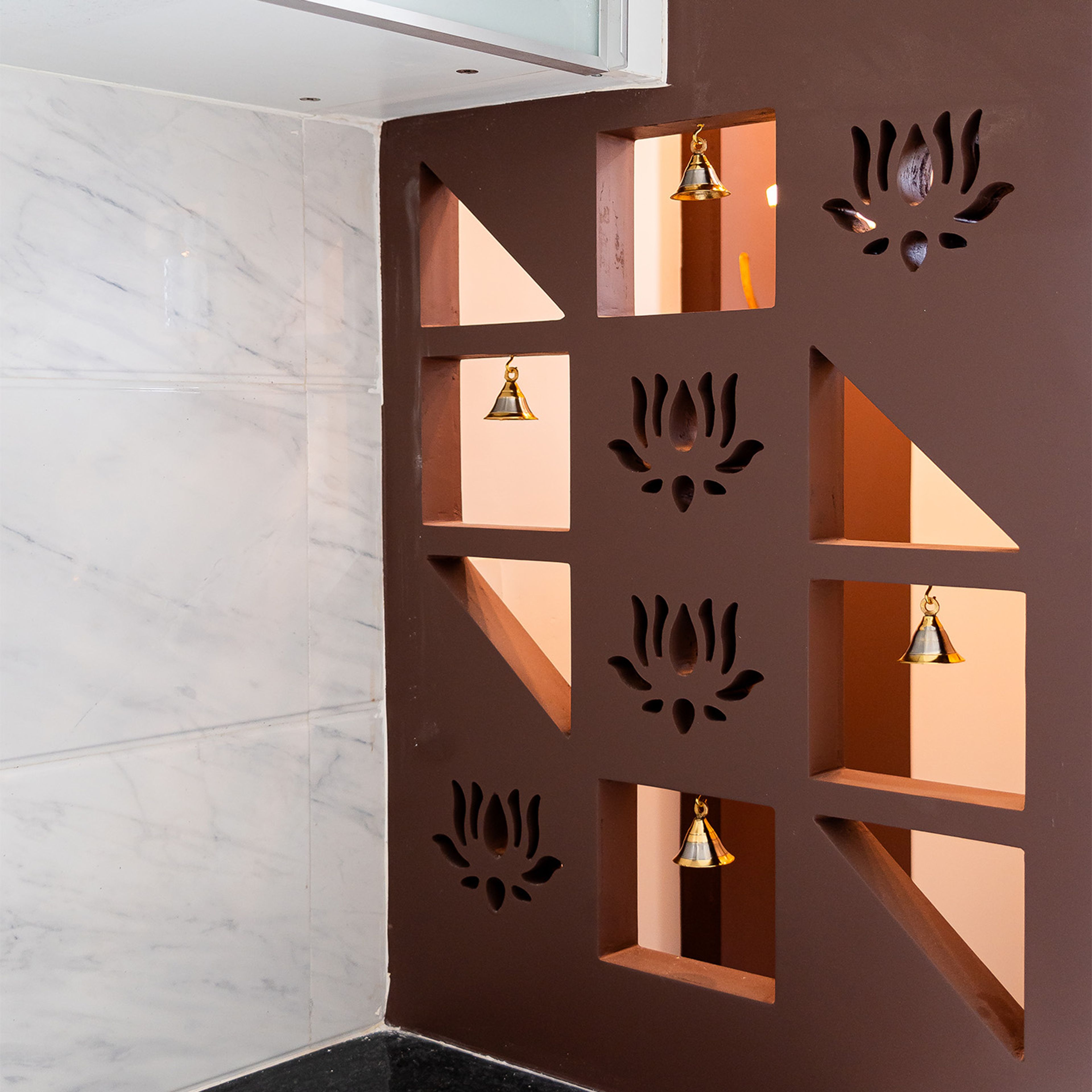 Pooja unit with brown panel with floral cuts and bells