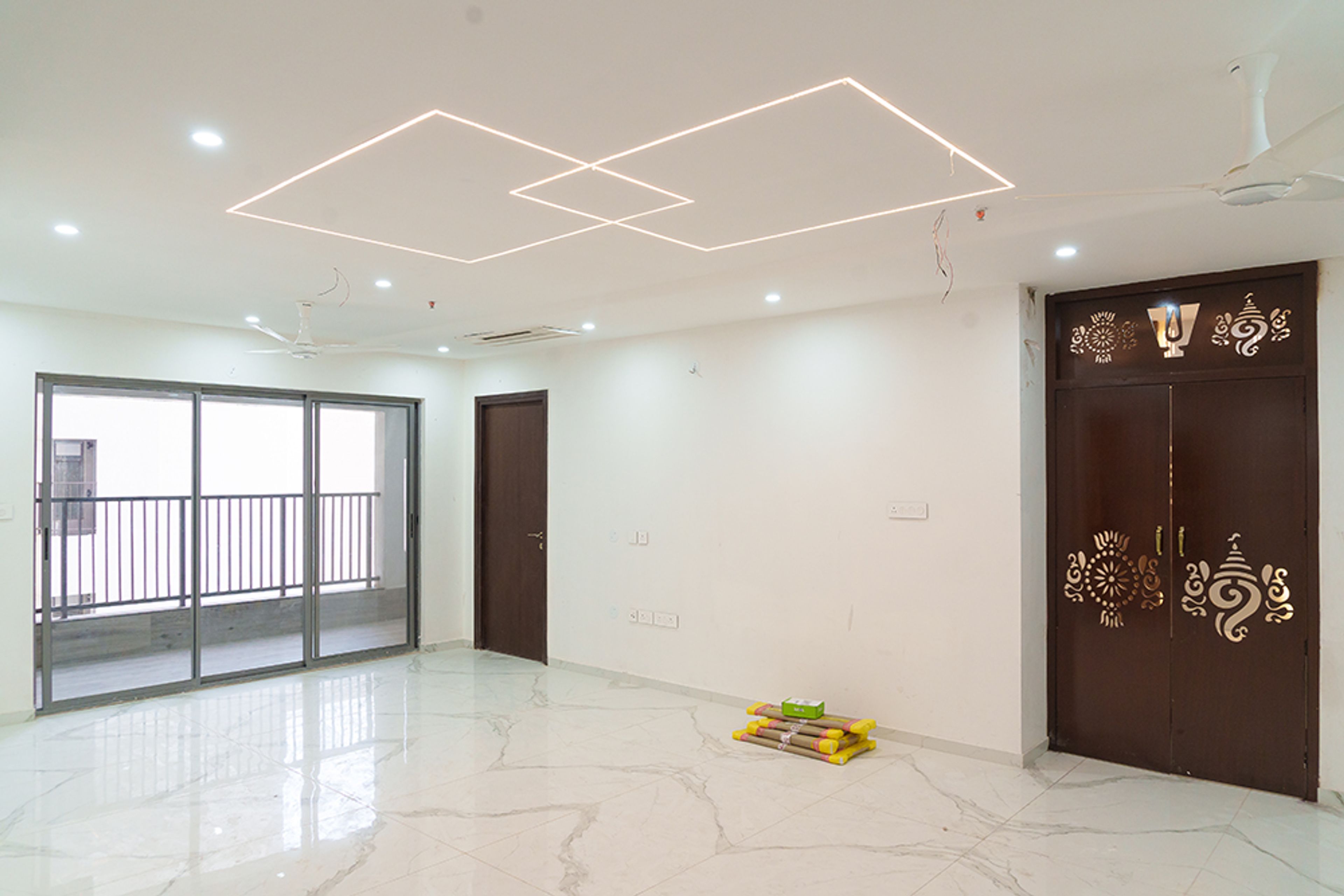 Living room design with wooden ganesha engraved door