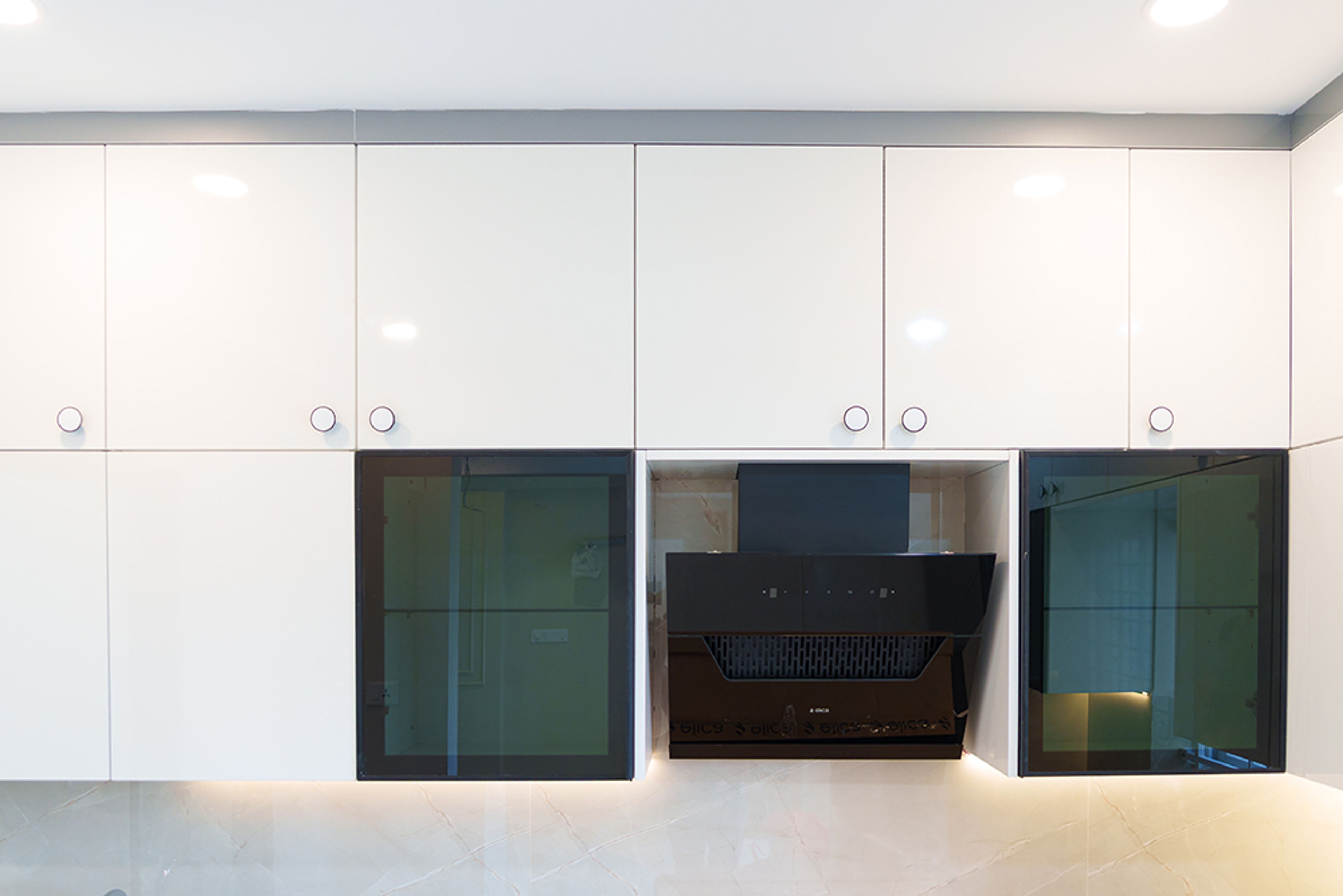 Straight Kitchen Design with Beige Wall Units and Black Glass Shutters