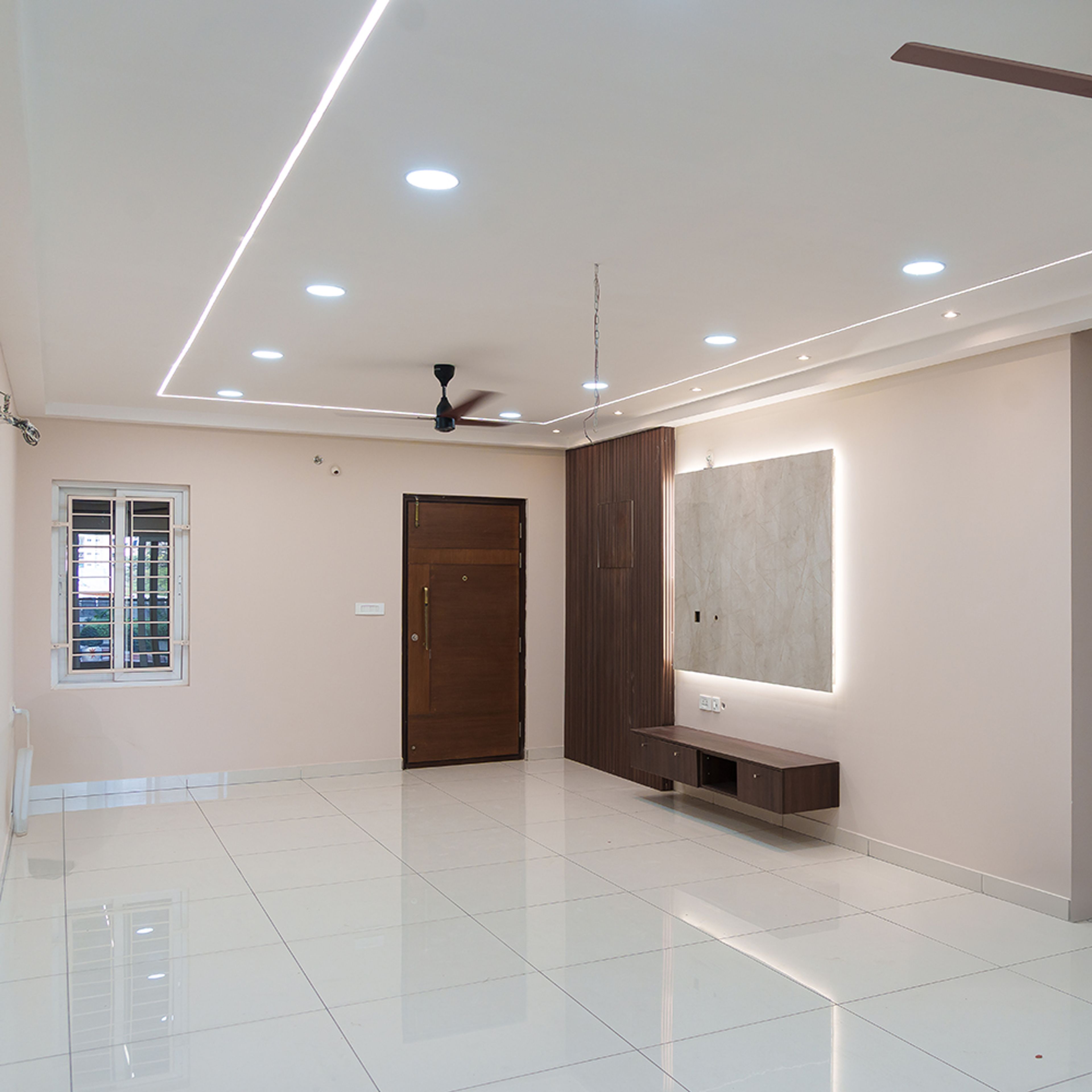 Living Room Design with Wooden TV Unit and Single Layer False Ceiling with Spotlights