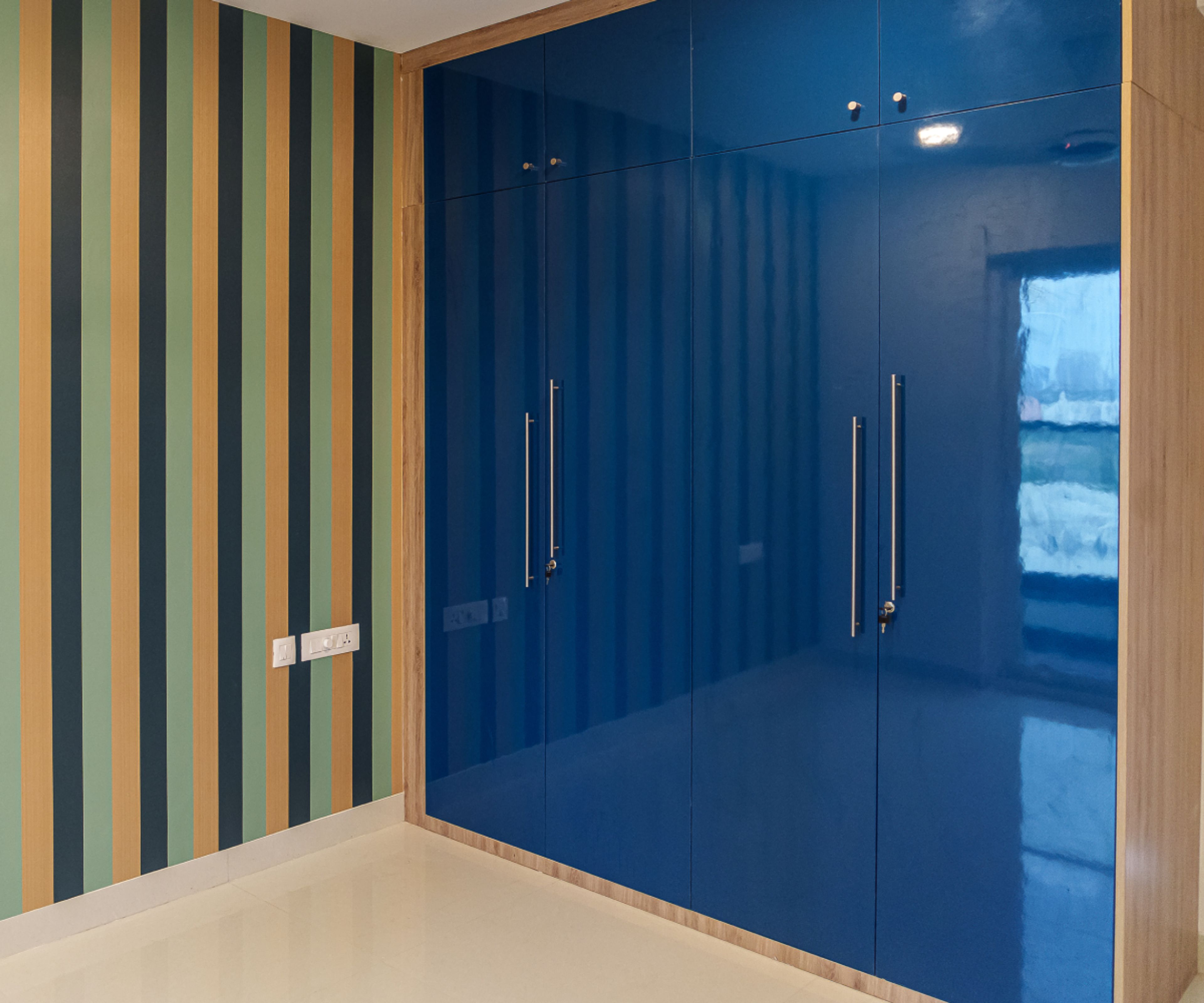4-Door Dark Blue Swing Wardrobe Design with Vertical Stripes Pattern Wall