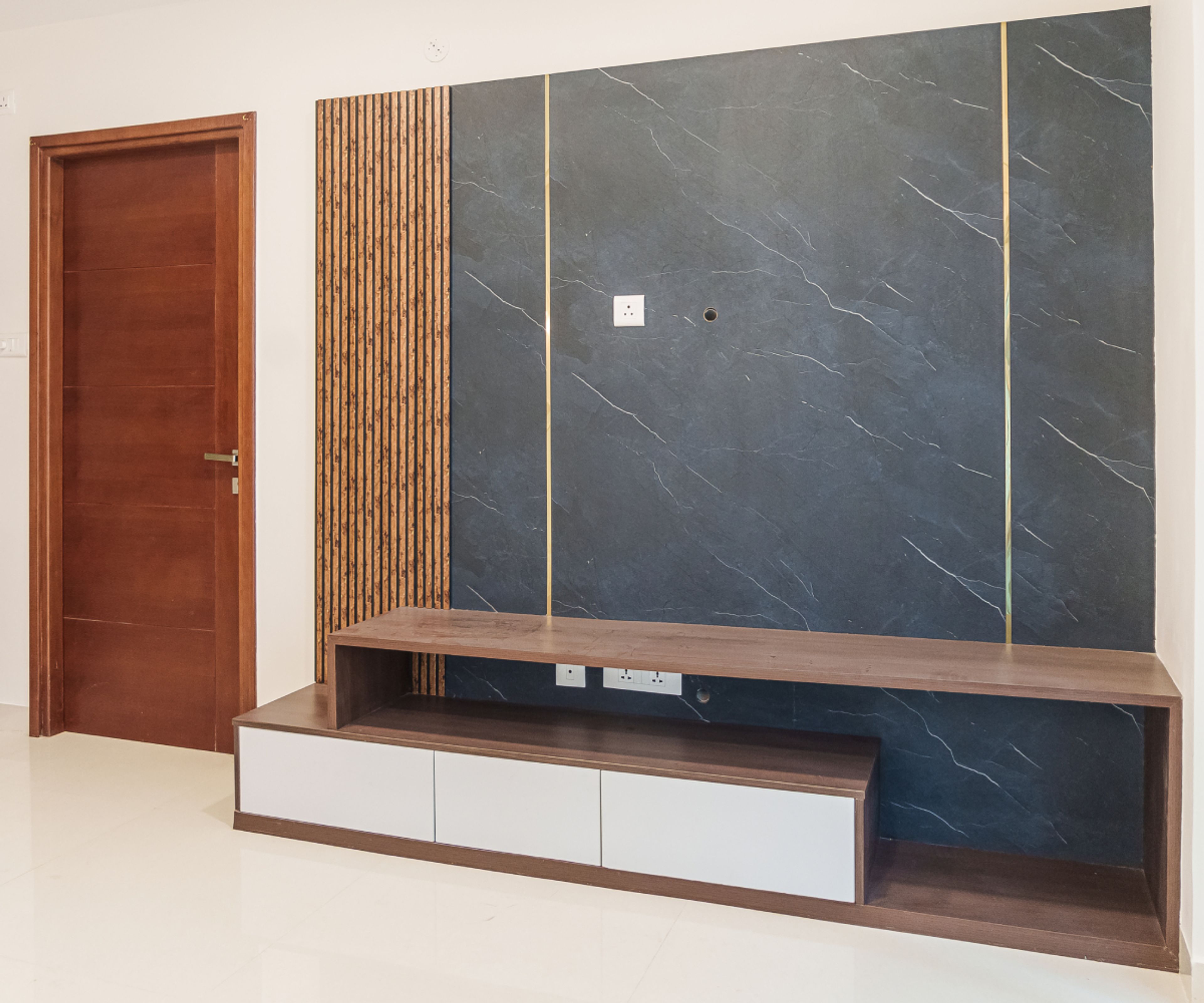 TV Unit Design With a Black Marble-Textured Panel and Fluted Side Panel