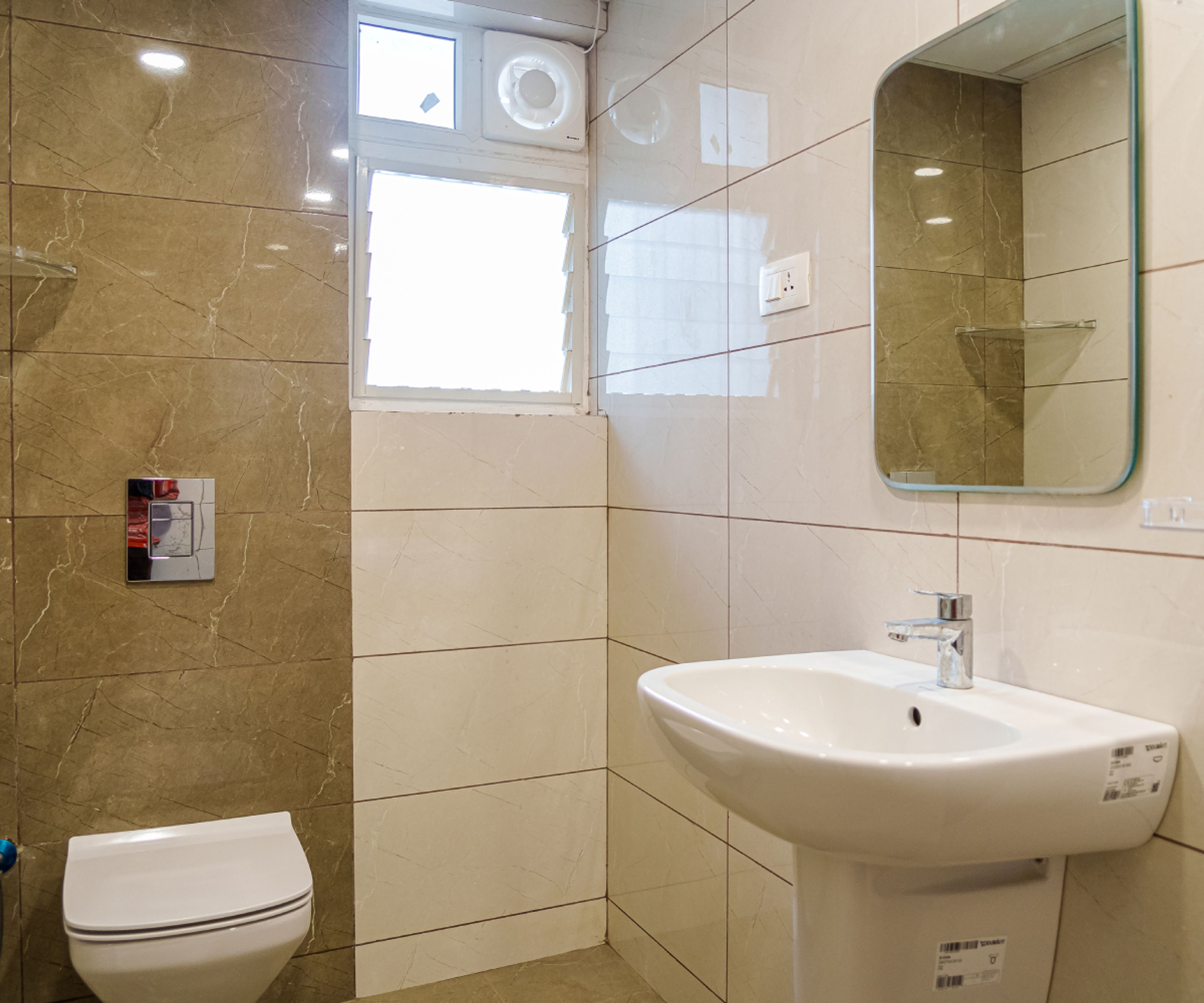 Bathroom Design With Beige and Brown Tiles and Square Mirror