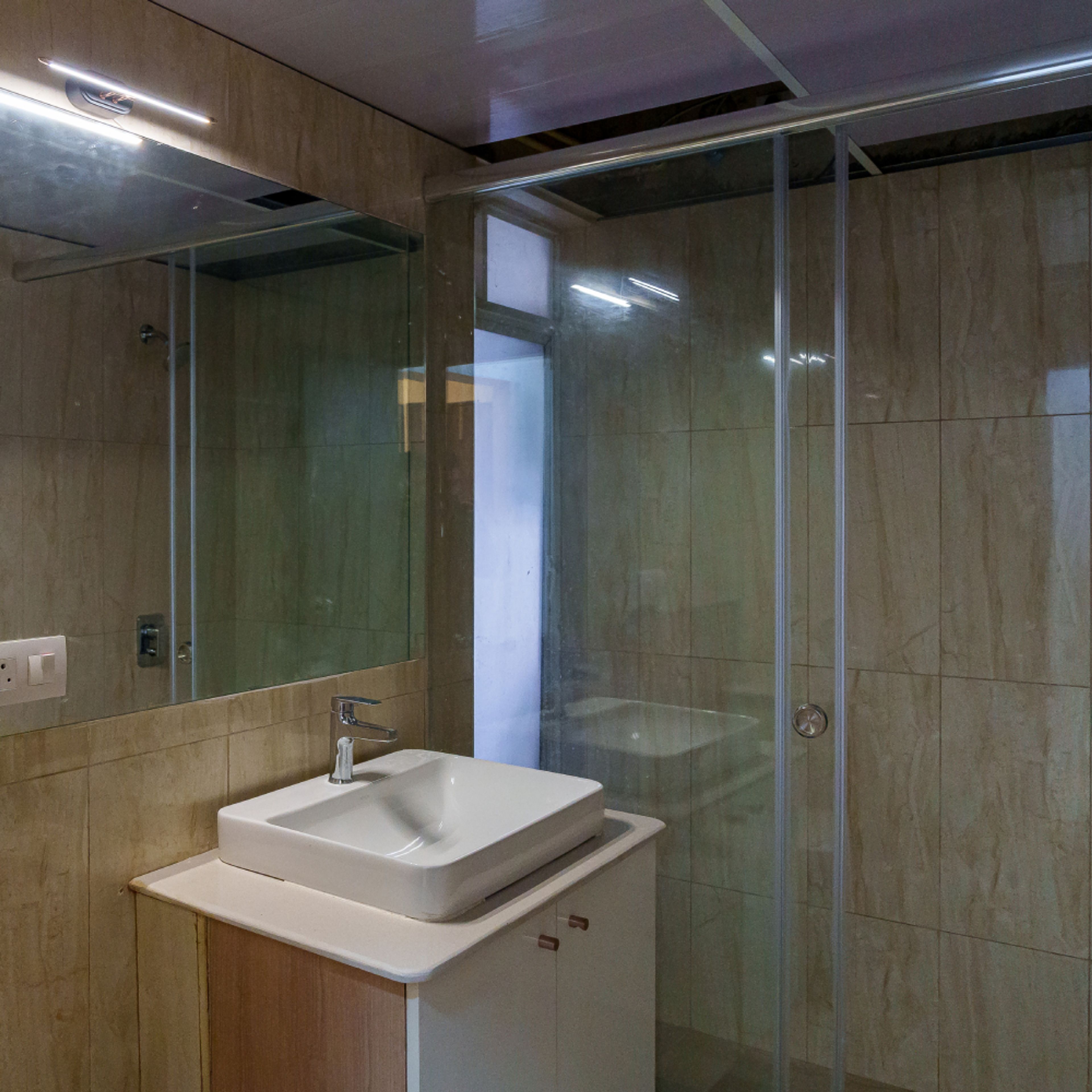Bathroom Design with White Cabinet and Glass Partition Shower Area