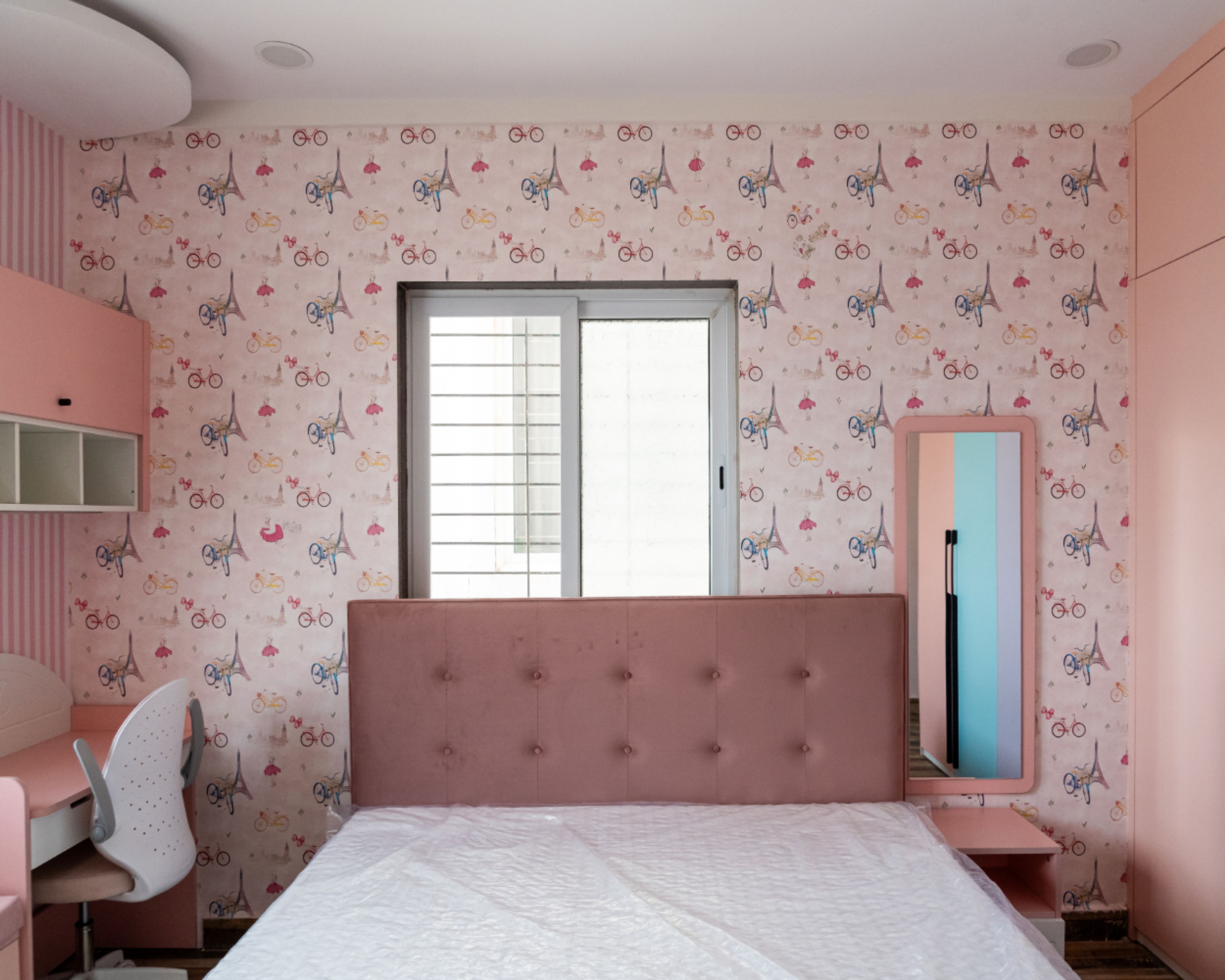 Kids Bedroom Design with Pink Bicycle and Eiffel Tower Themed Wallpaper, and Pink Wall Mounted Mirror