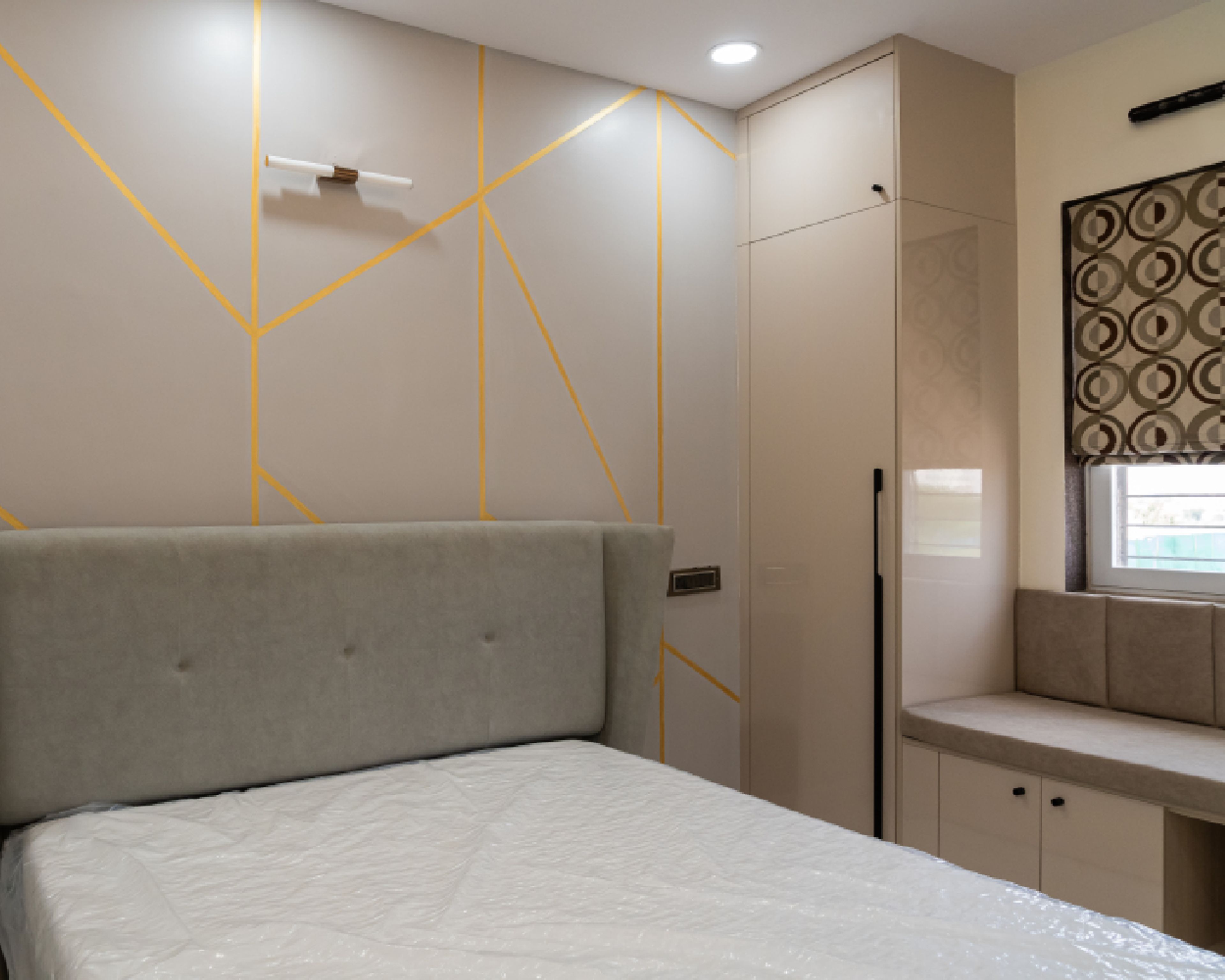 Guest Bedroom Design with Geometric Gold-Lined Patterns, Soft Beige Finish, and Wall and Cove Lights