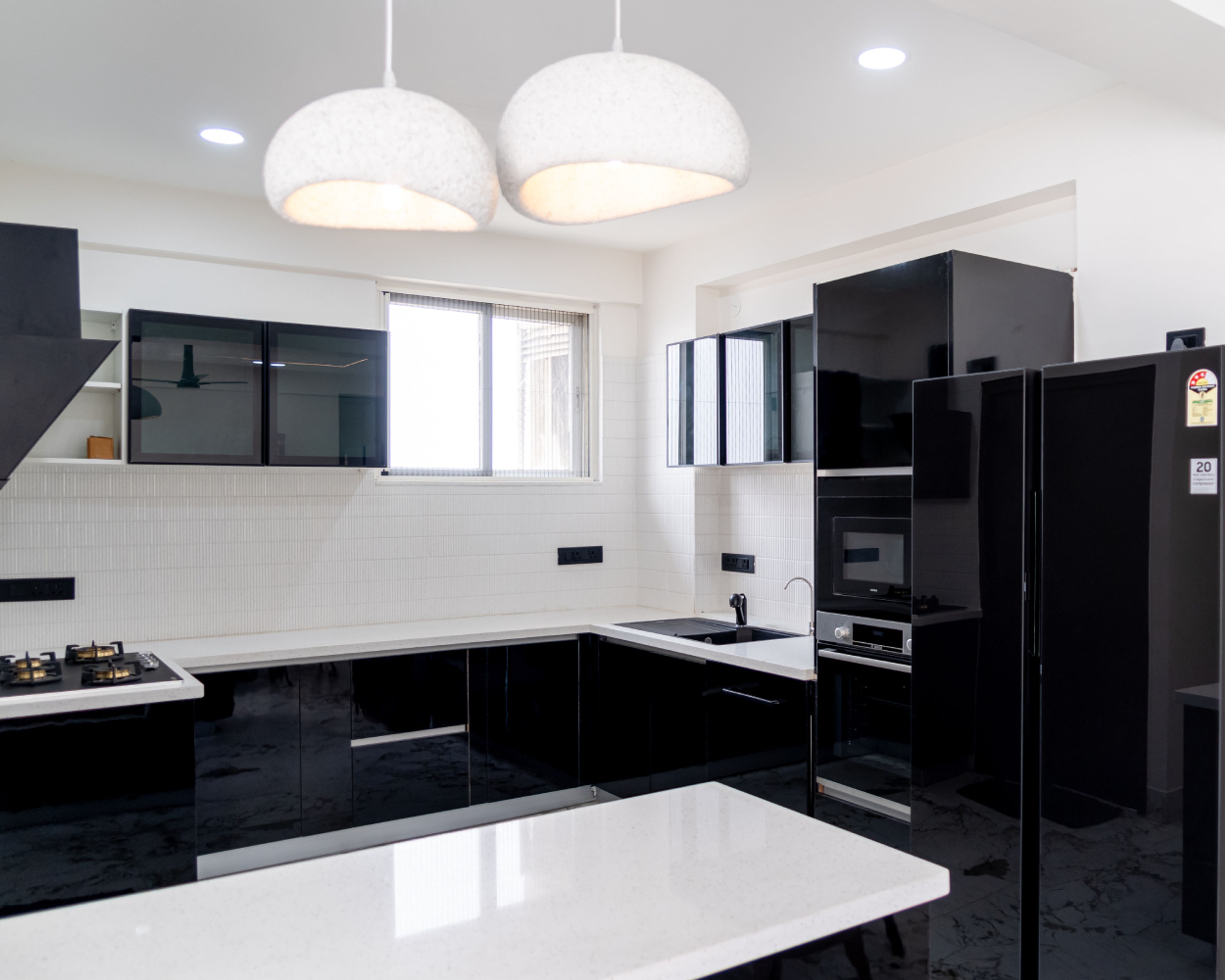 Black Island Kitchen Design With Glossy Cabinets and Quartz Top