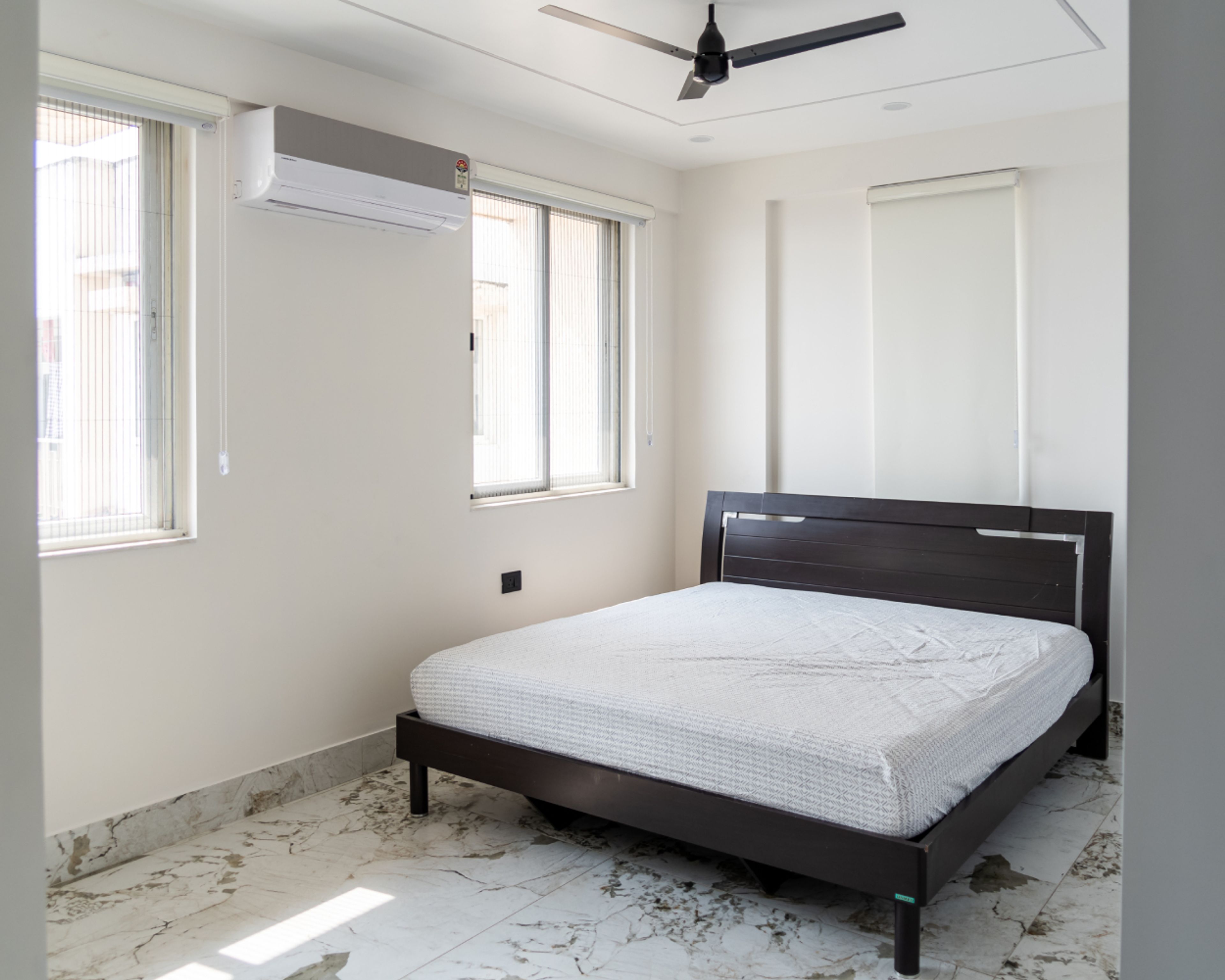 Master Bedroom Design with White Walls and Marble Pattern Flooring