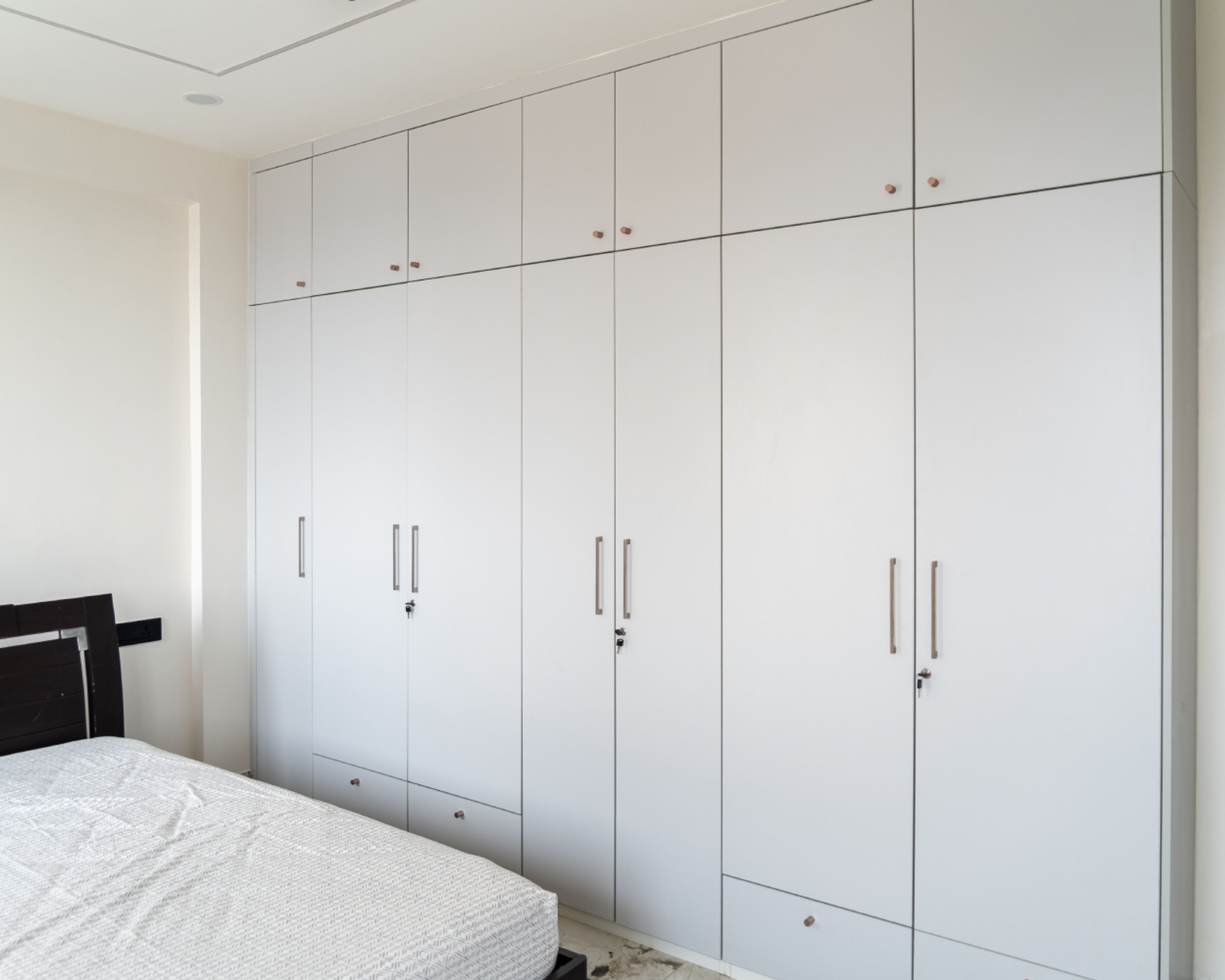 Master Bedroom Design with 7-Door Off-White Swing Wardrobe with Loft Unit