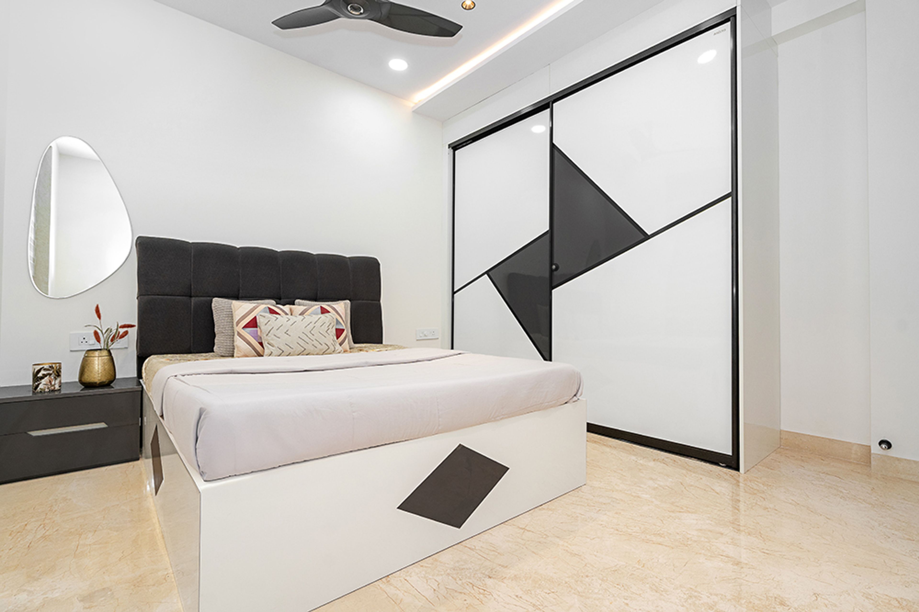Bedroom Design with Black Tufted Headboard Bed and 2-Door White and Black Geometric Design Sliding Wardrobe