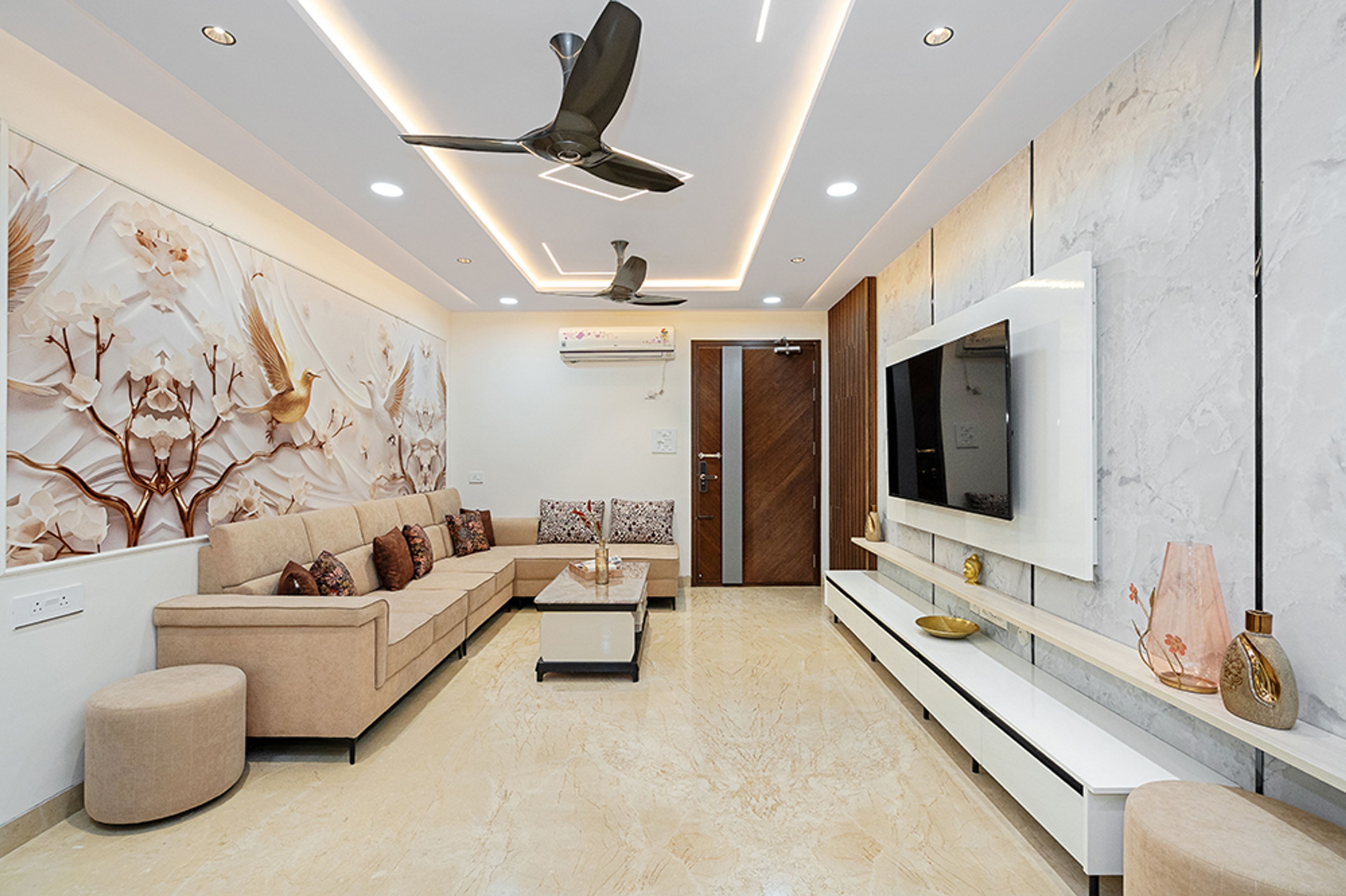Living Room Design with Beige L-Shaped Sofa, Bird Themed Wall and White TV Unit