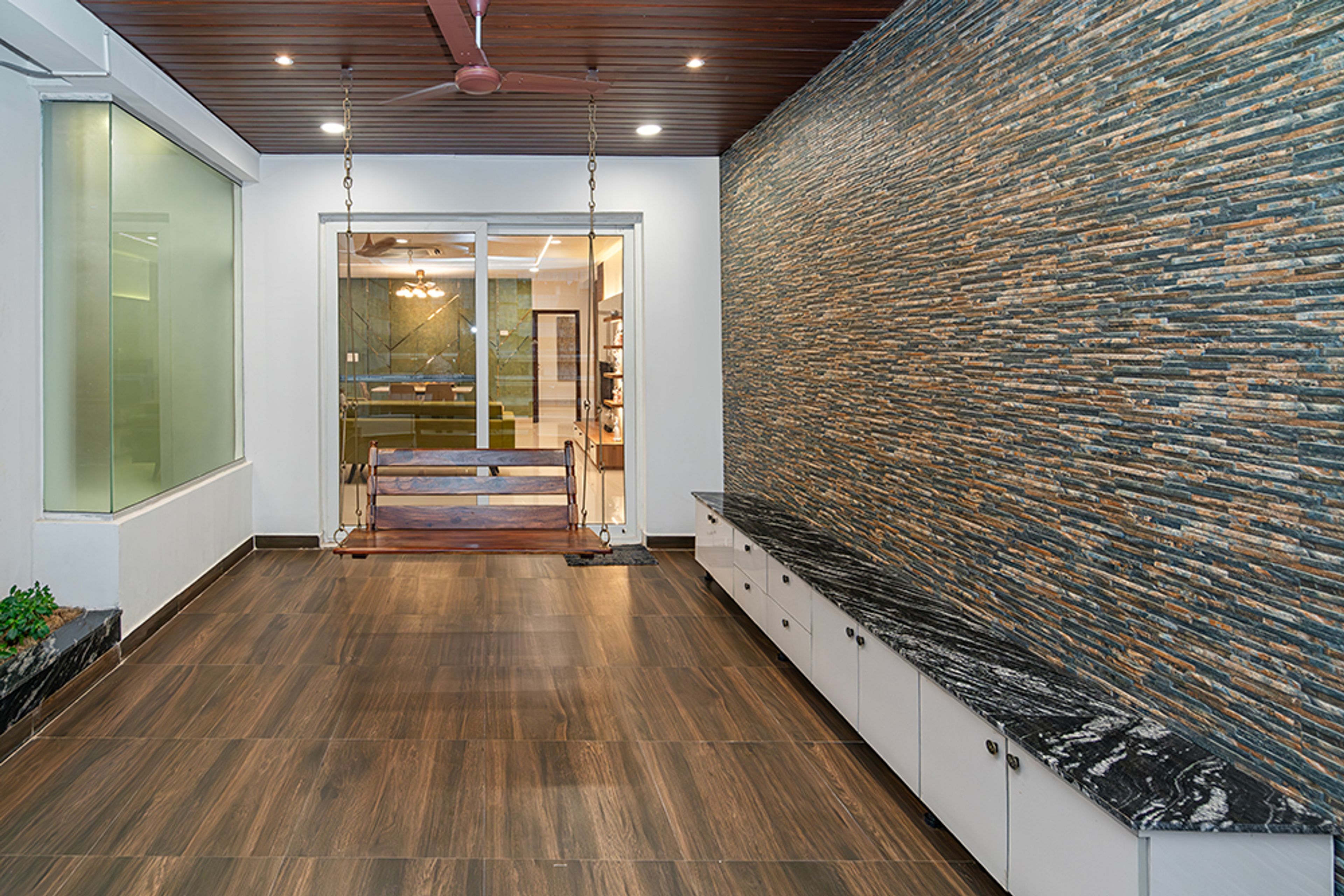 Blacony Design with Wooden Swing and Stone Cladding wall