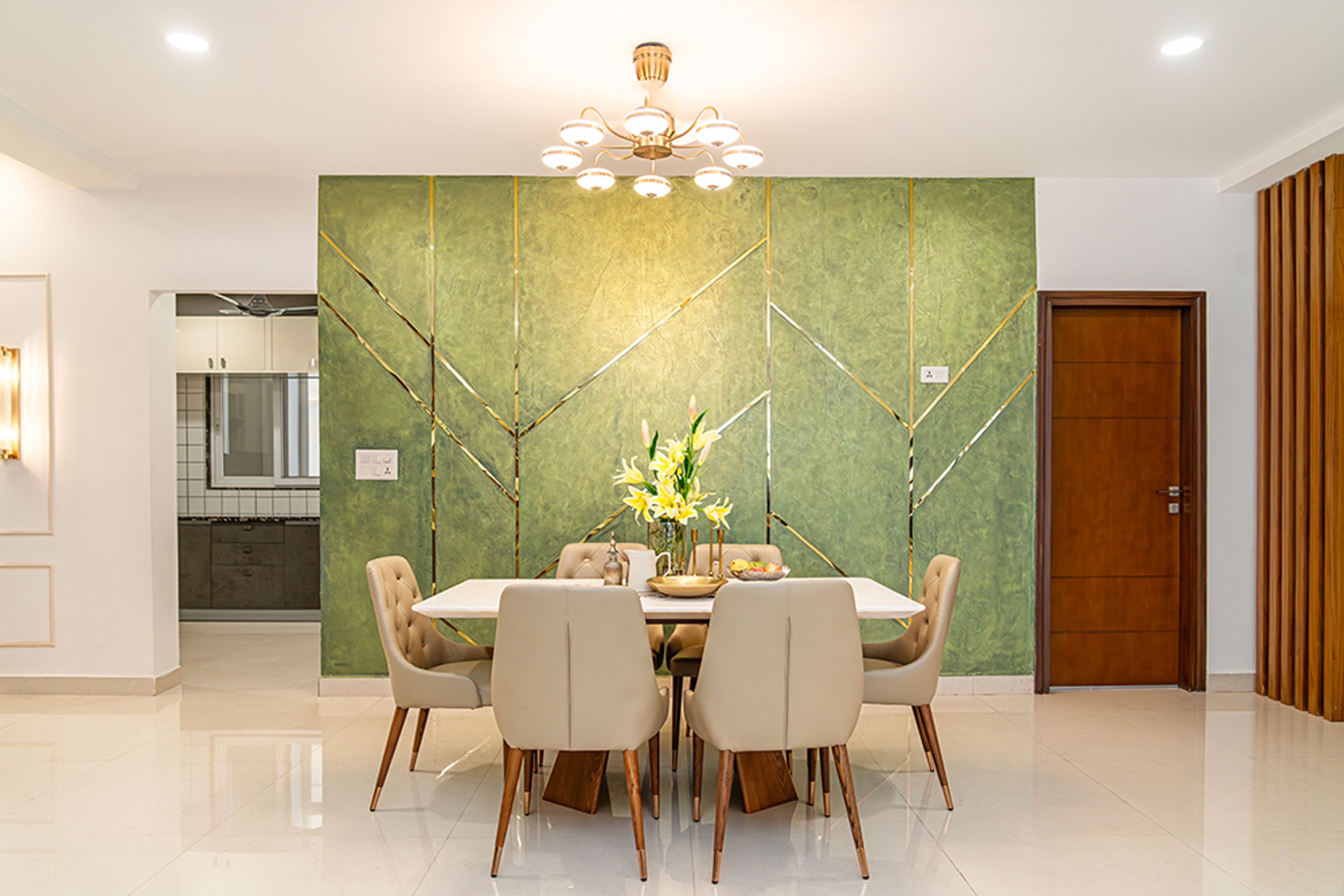 Dining Area with 6 Cushioned Chairs and Green Textured Wall with Gold Inlays