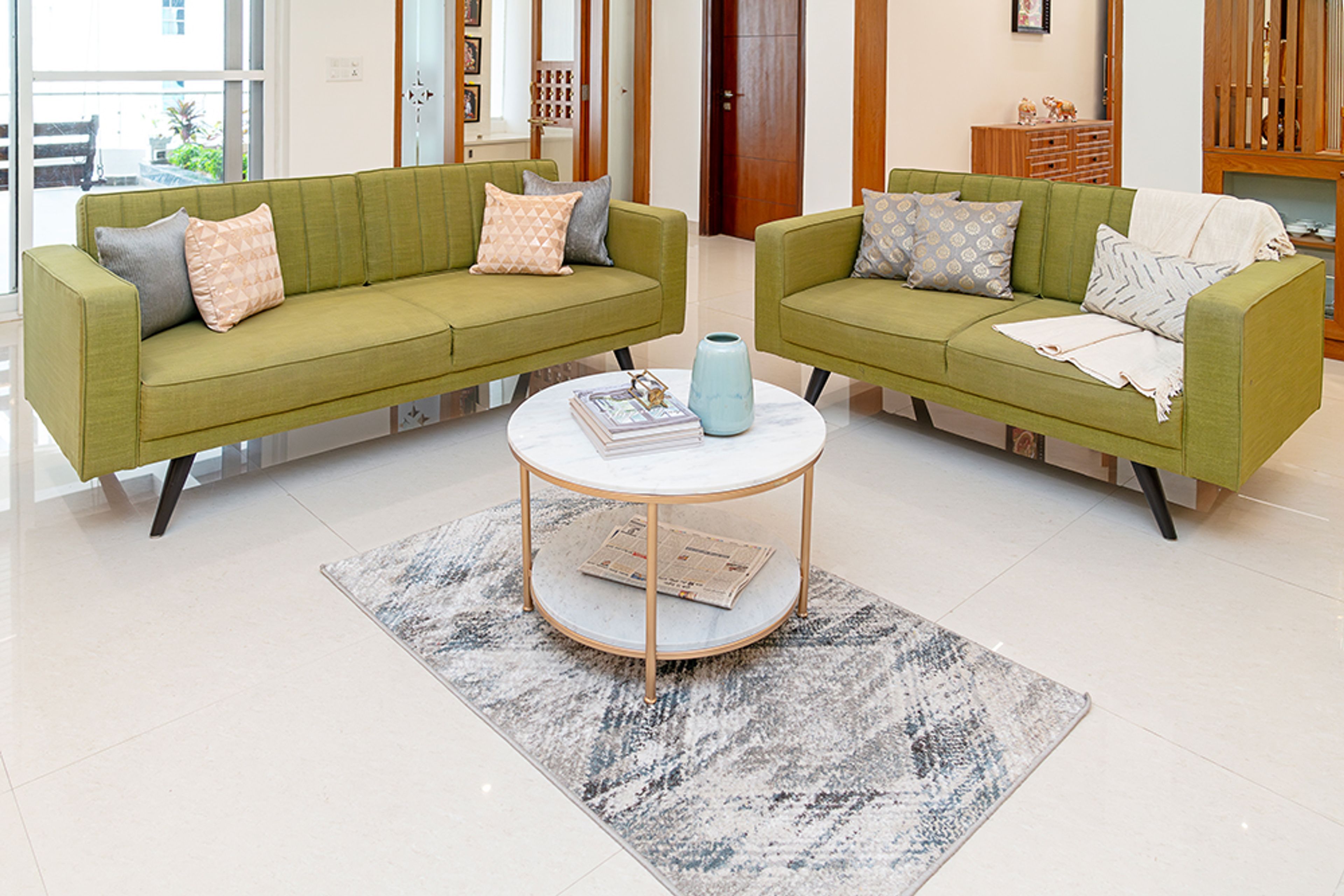 Living Room Design with Two Green Sofas and Round Marble Table