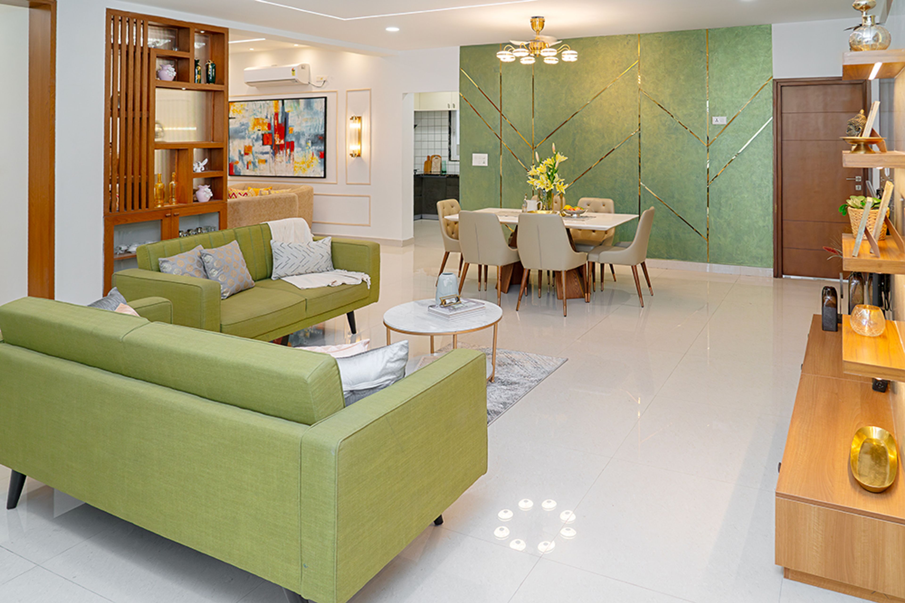 Living Room Design with Green Sofas, Dining Table and Green Wall with Gold Inlays