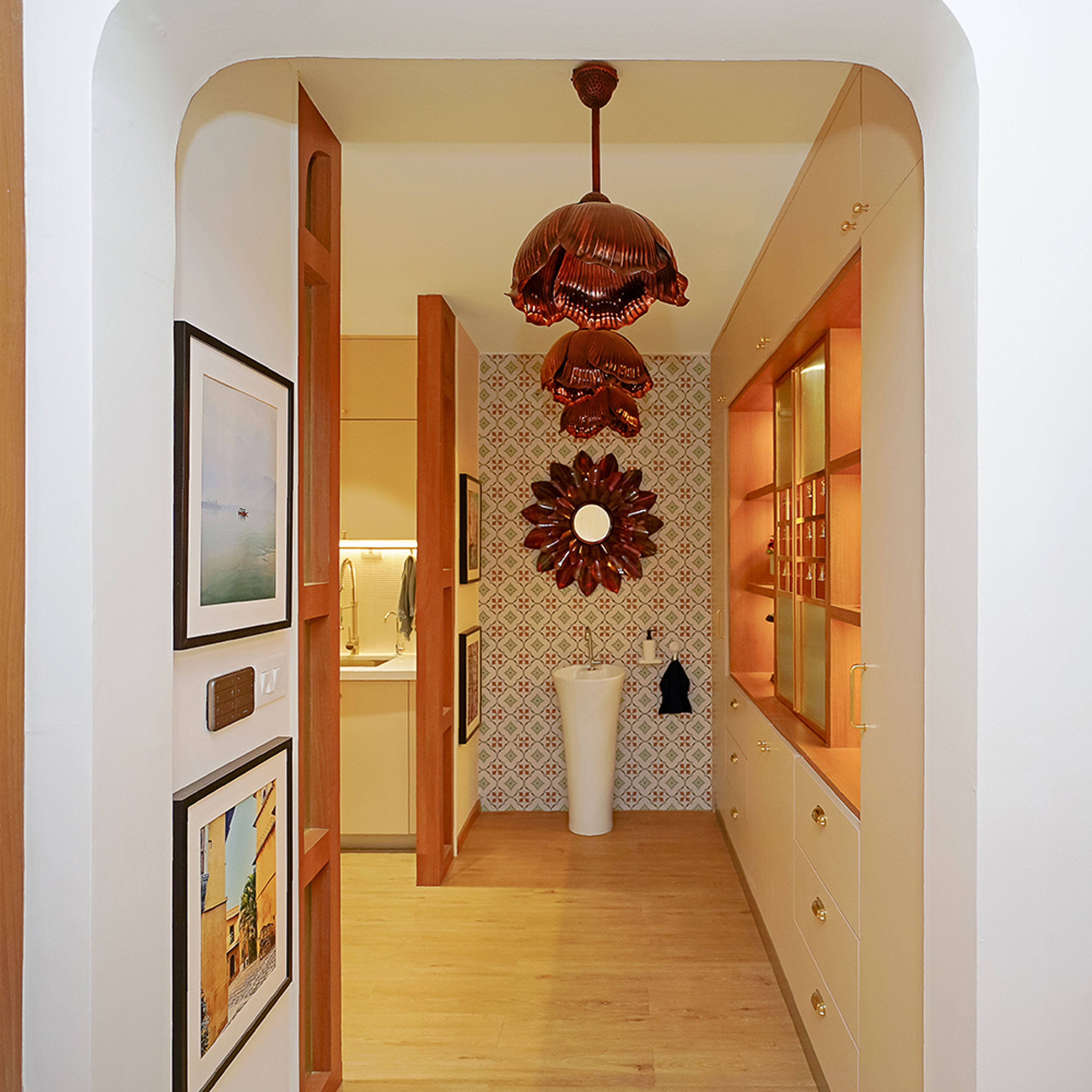 Foyer Design with Hanging Copper Coloured Floral Lights and Sink