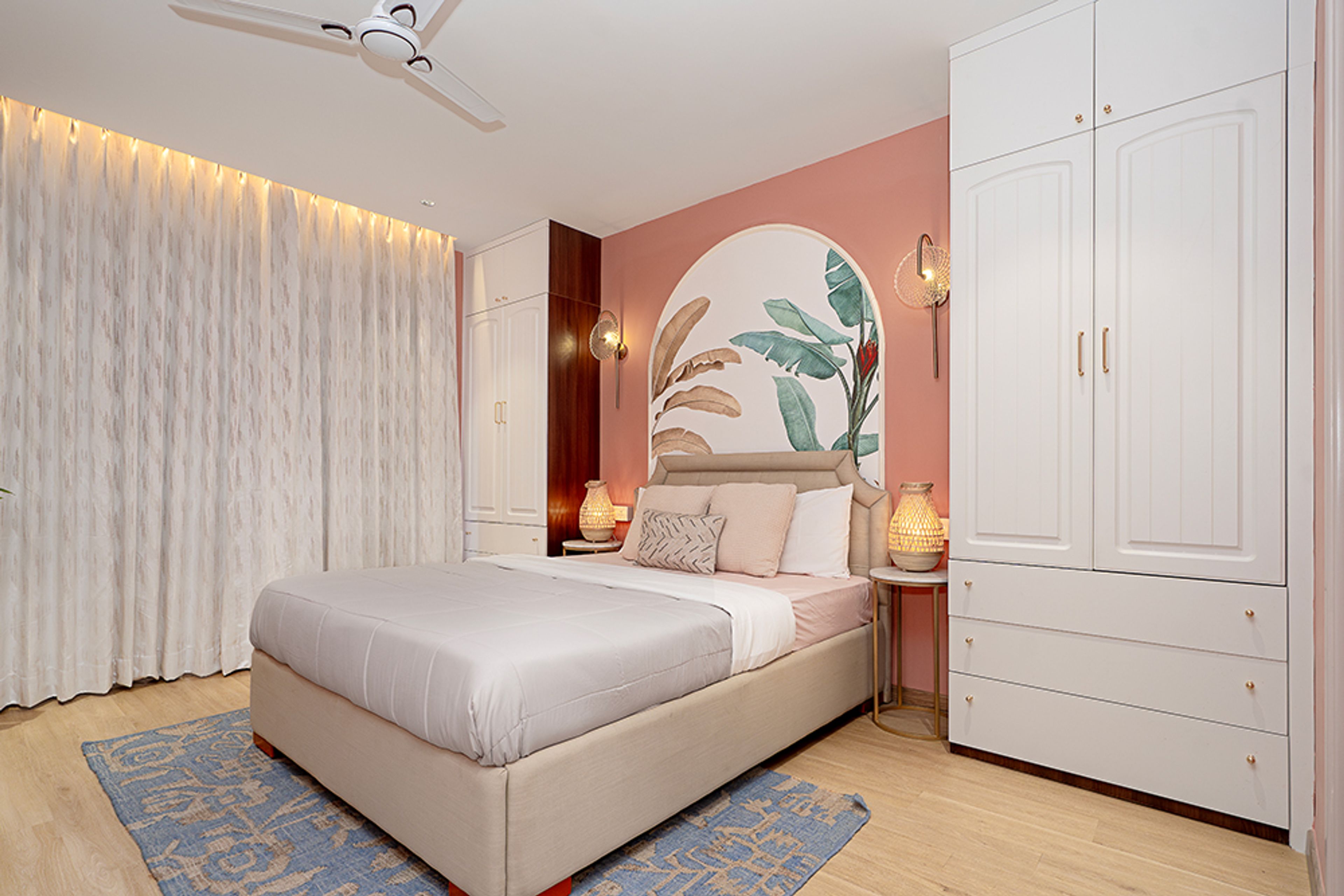 Bedroom Design with Peach Wall and Floral Wall Arch with 2-Door White Wardrobe