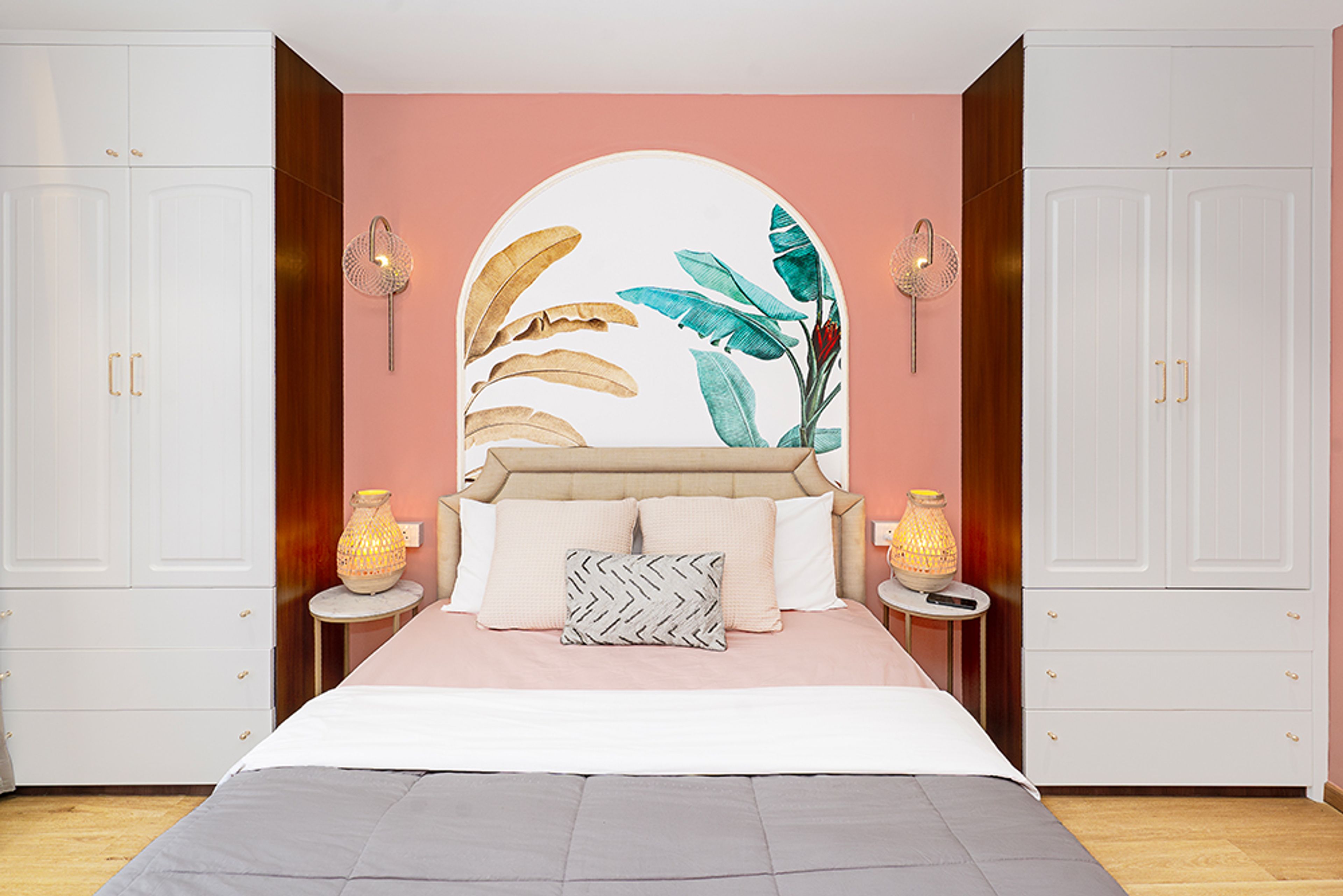 Bedroom Design with Peach Wall and Floral Wall Arch with Two 2-Door White Wardrobes