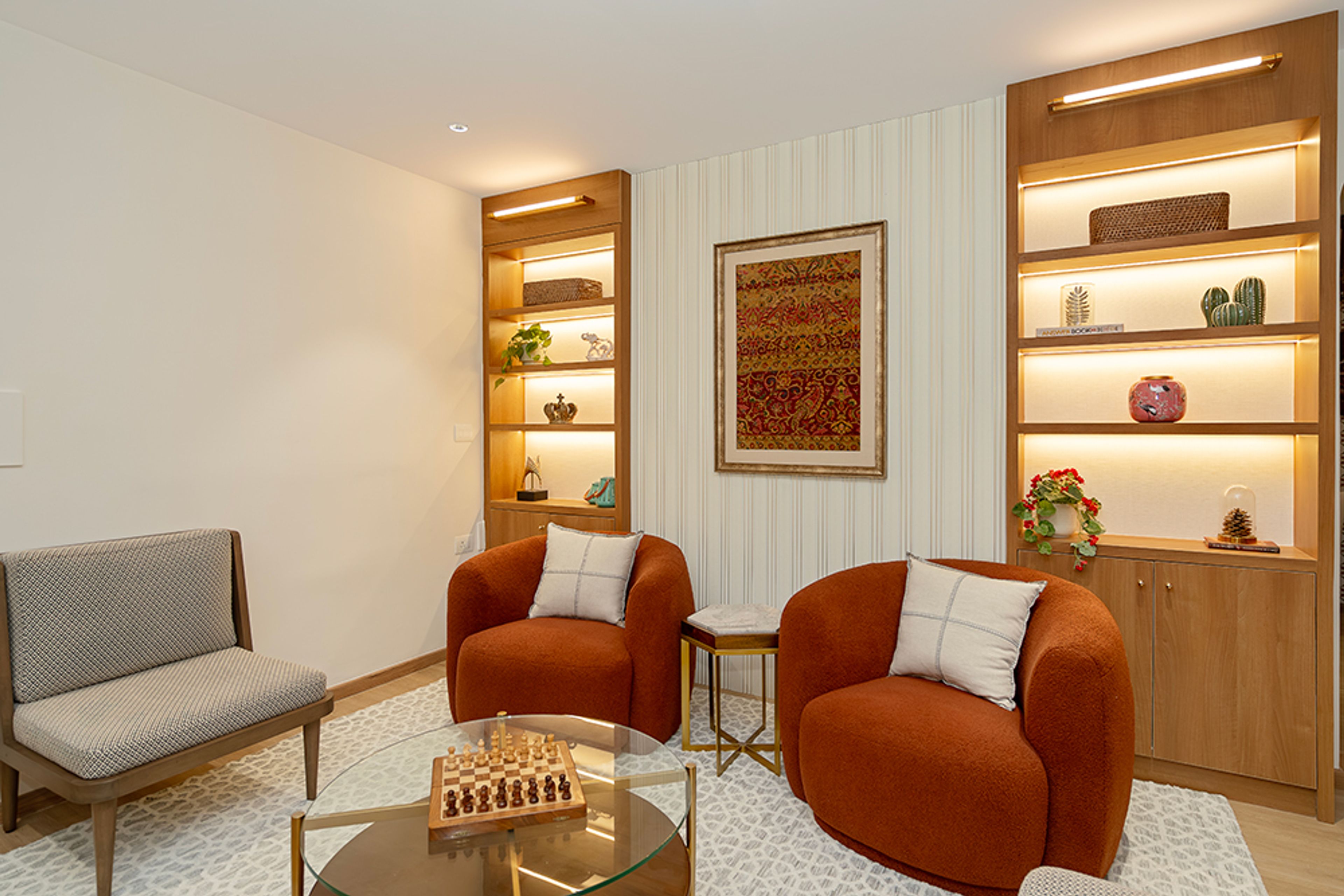 Living Room Design with Two Orange Accent Chairs and Wooden Wall Niche Display