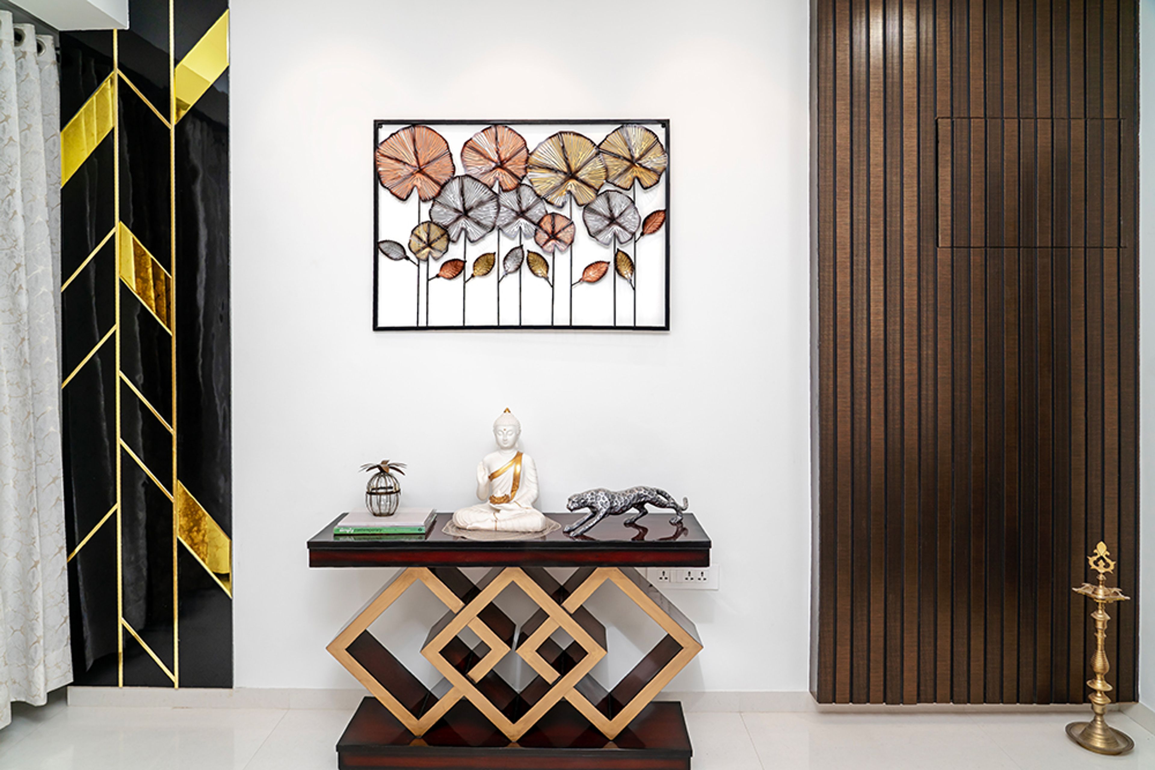 Foyer Design with Geometric Console with Budhha Idol, Metallic Accents, and Sculptural Wall Art
