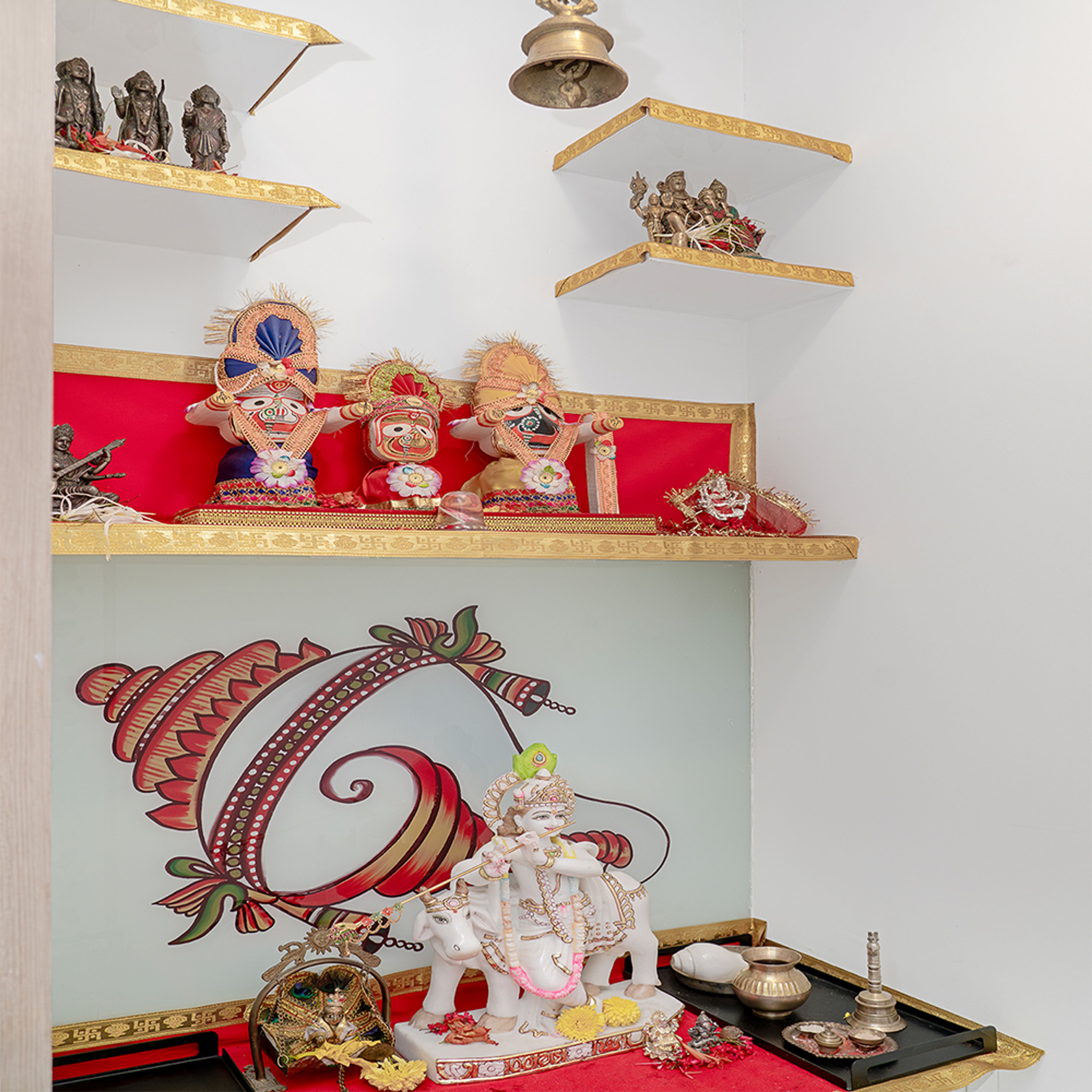 Pooja Unit with Floating Wall Shelves and Shankh Painting on the Wall