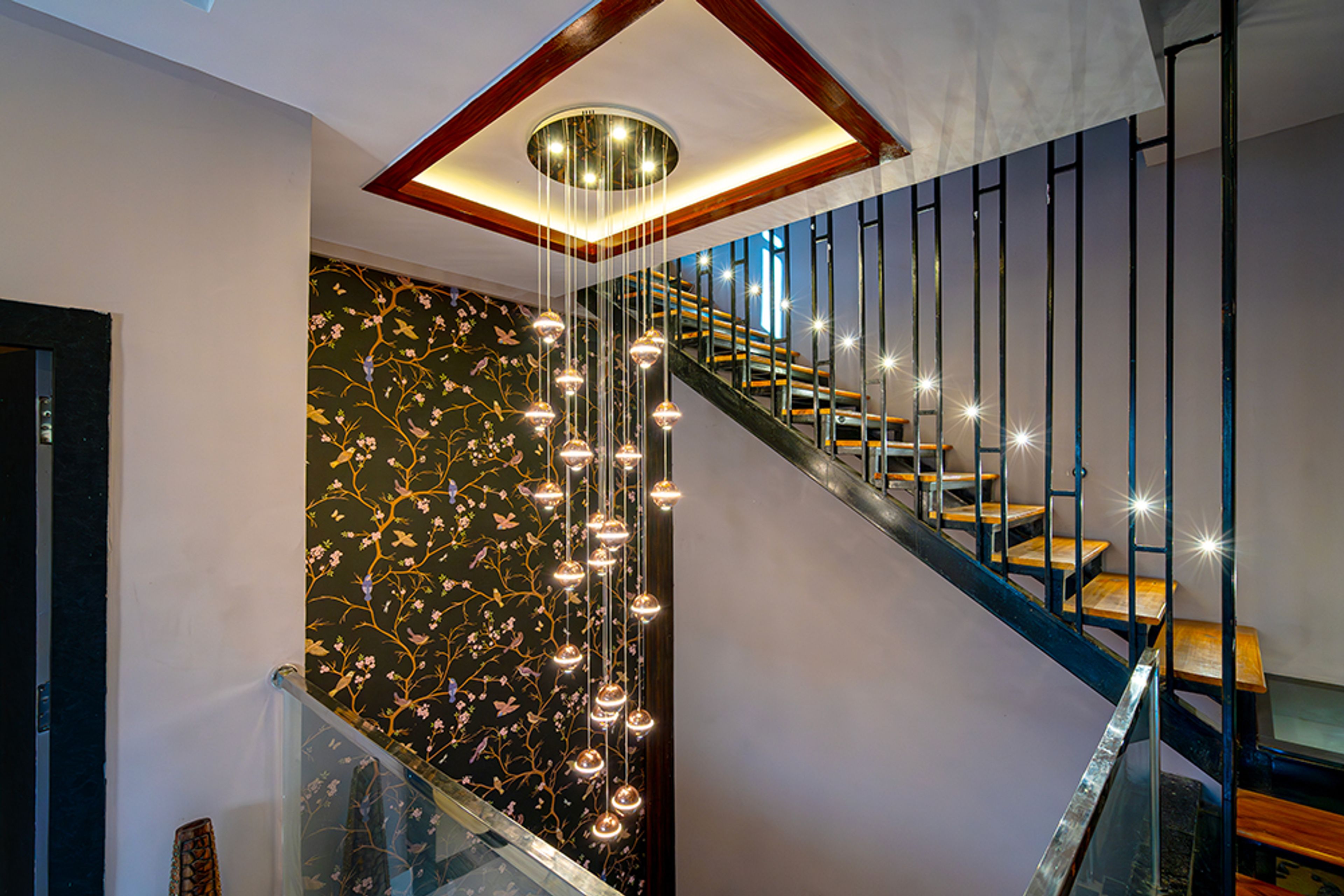 Floating Wooden Staircase Design With Black Metal Railings and Glass Balustrade