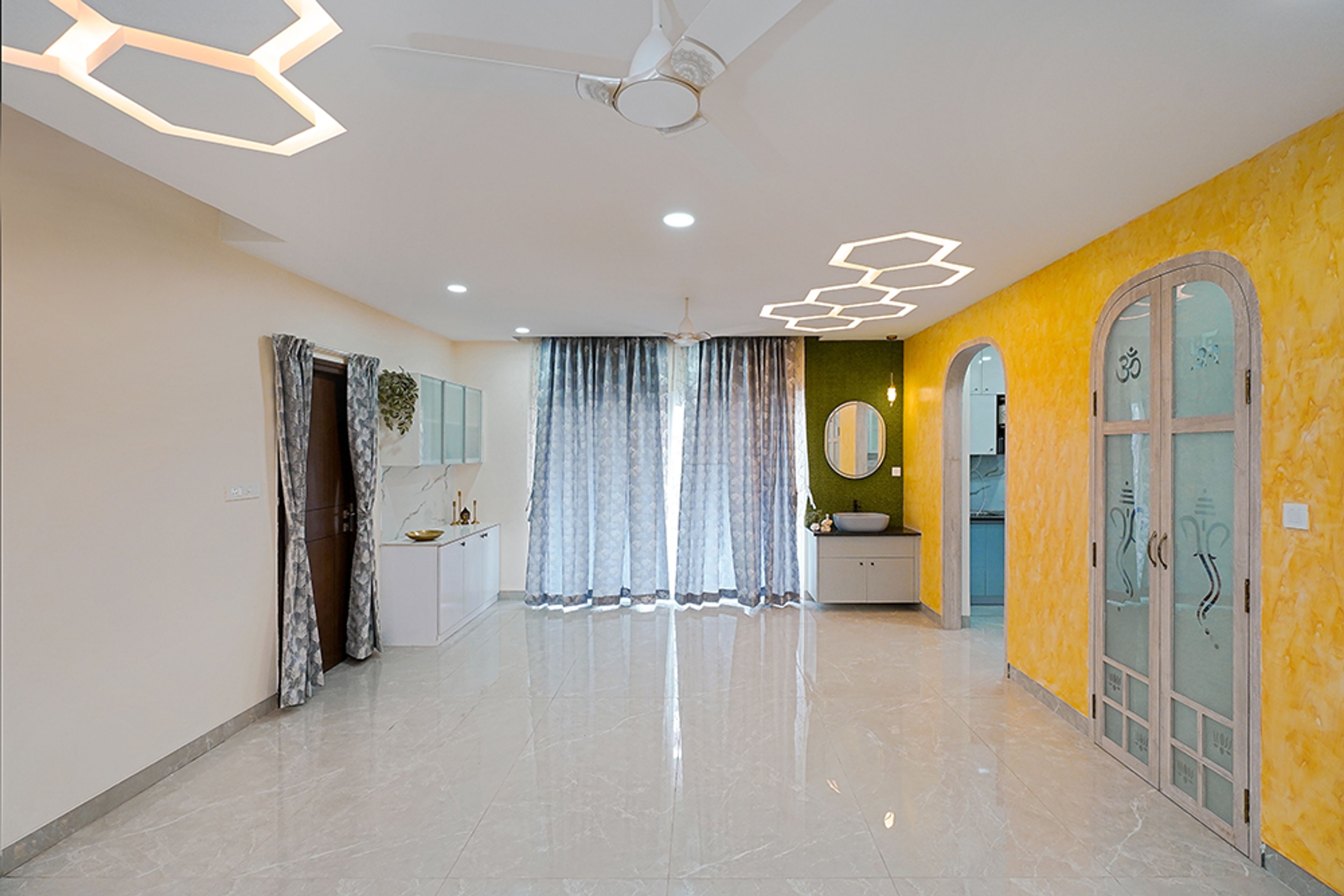 Living Room With Glossy Flooring, Geometric Ceiling Lights, Ganesha Glass Doors and Yellow Walls