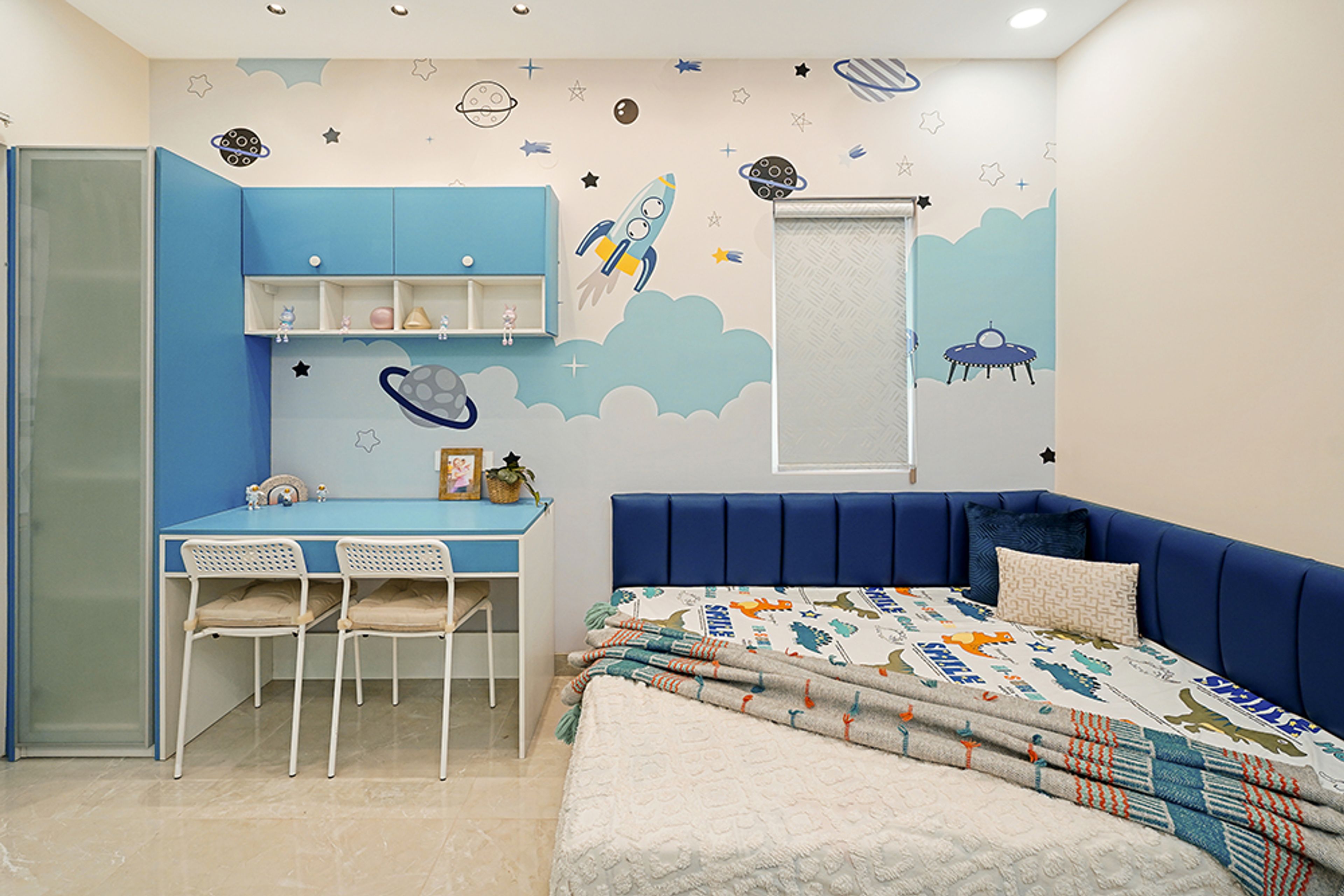 Space Themed Kids Bedroom With Navy Blue Bed and Light Blue Study Desk