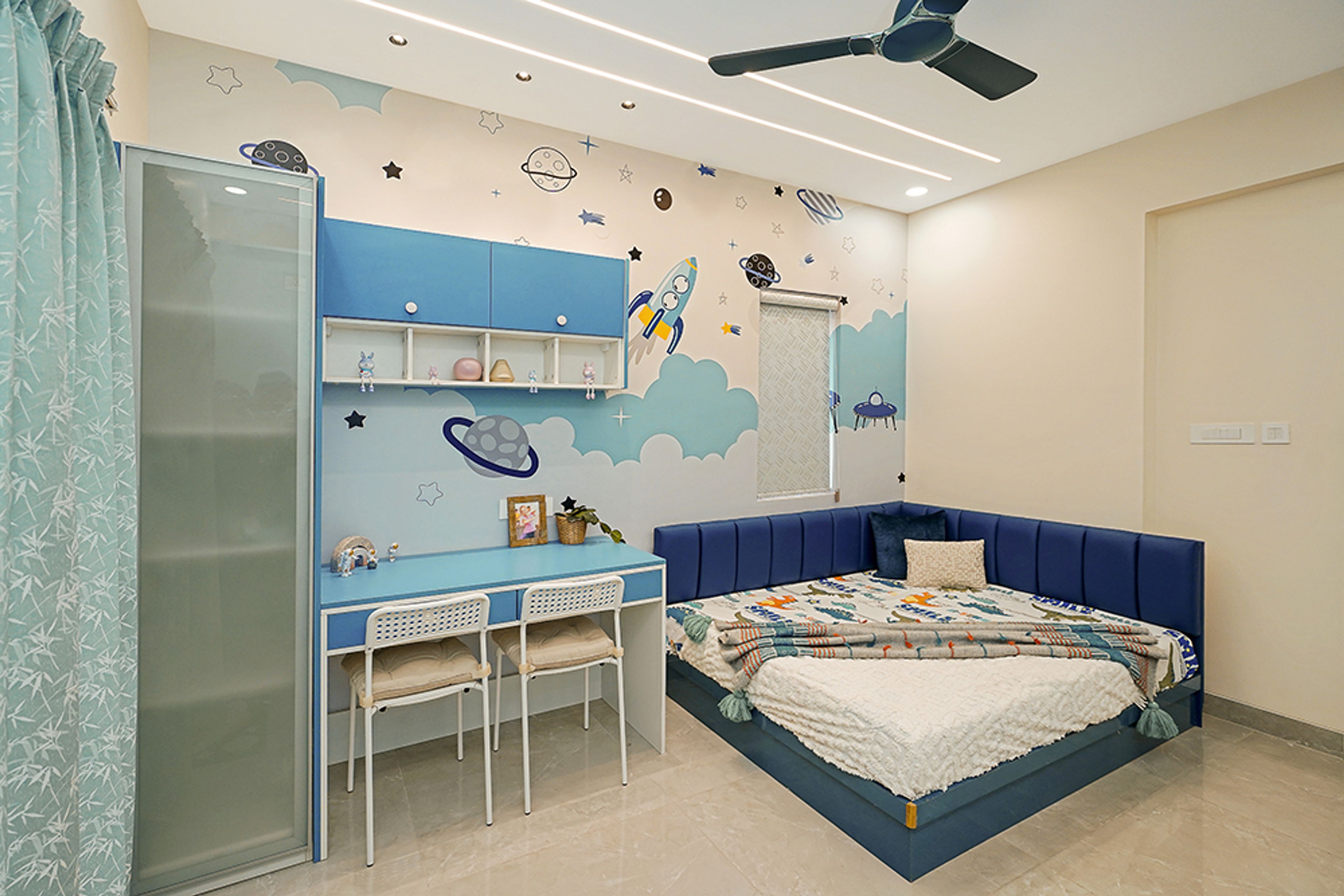 Space Themed Kids Bedroom With Navy Blue Bed and Light Blue Study Desk