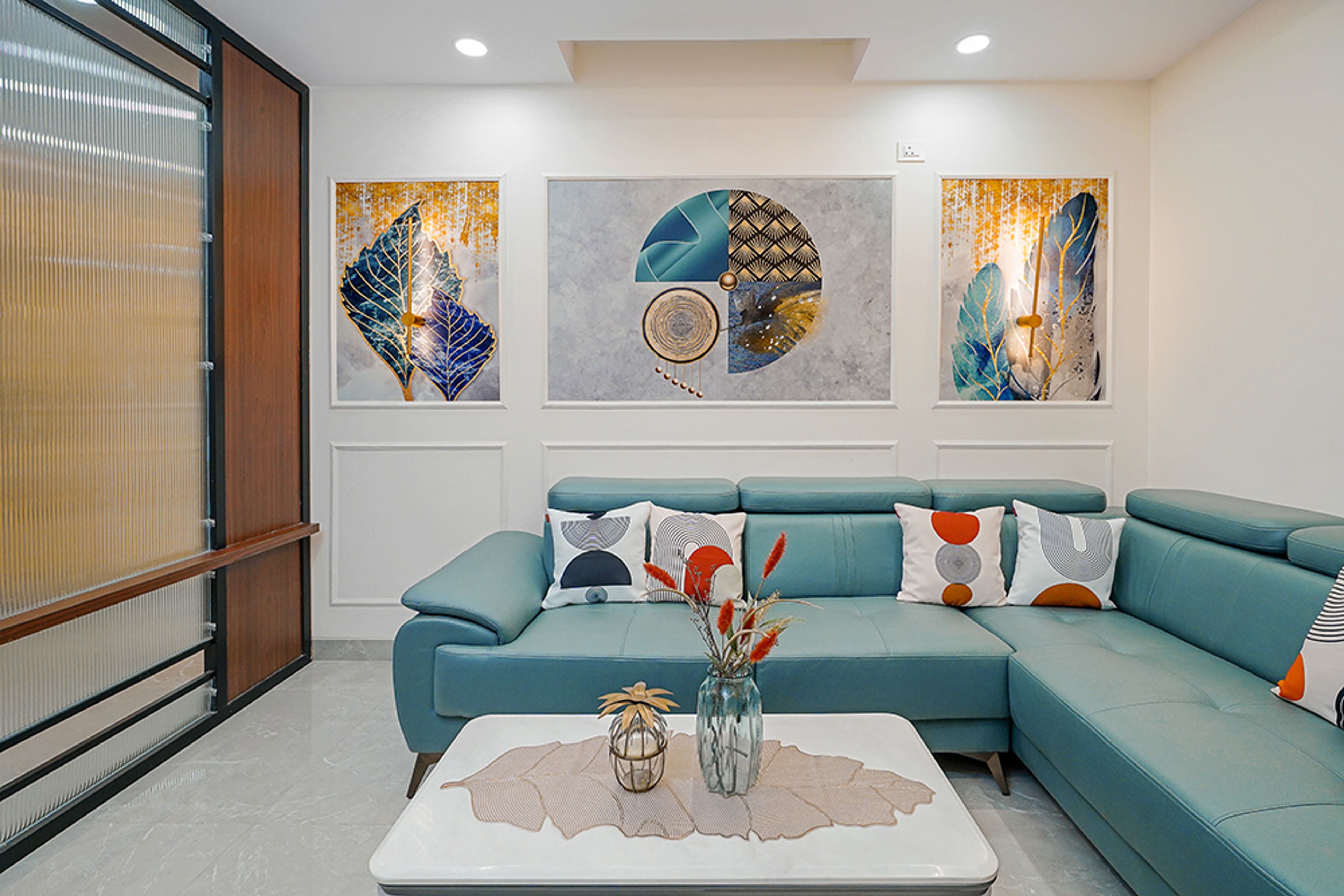 Living Room Design with Blue L-Shaped Sofa, Abstract Wall Art and White Center Table