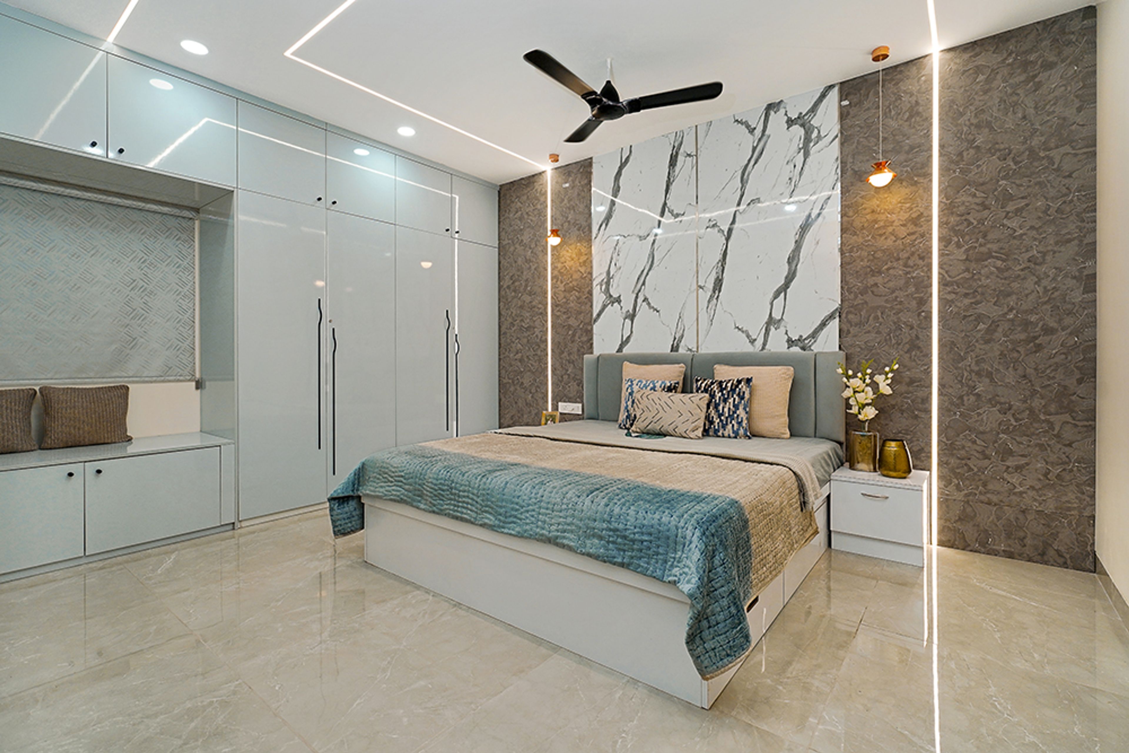 Bedroom Design with 4-Door Light Blue Swing Wardrobe and Marble Patterned Accent Wall