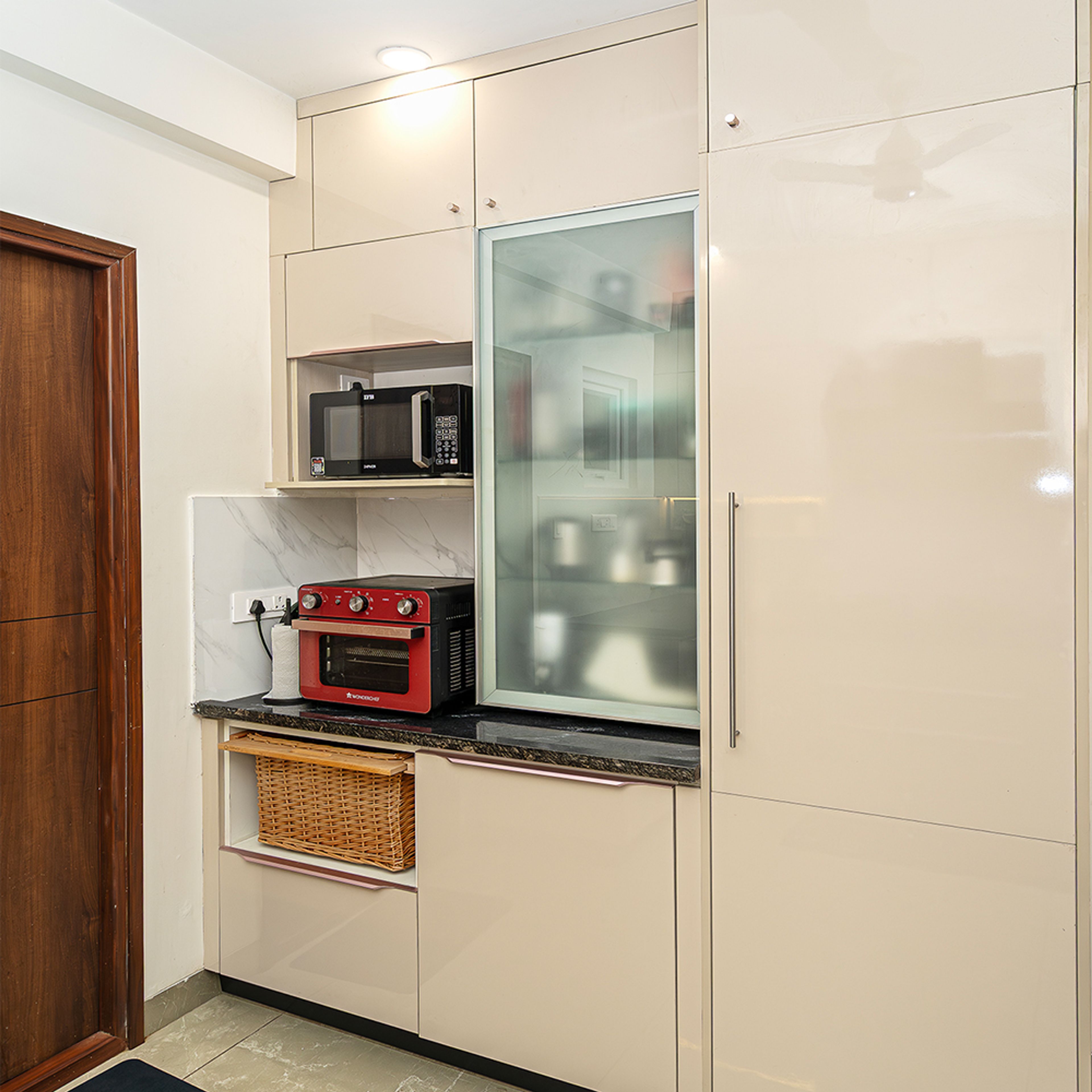 Modern Kitchen Design with Beige Storage Units in Hyderabad 3BHK Apartment