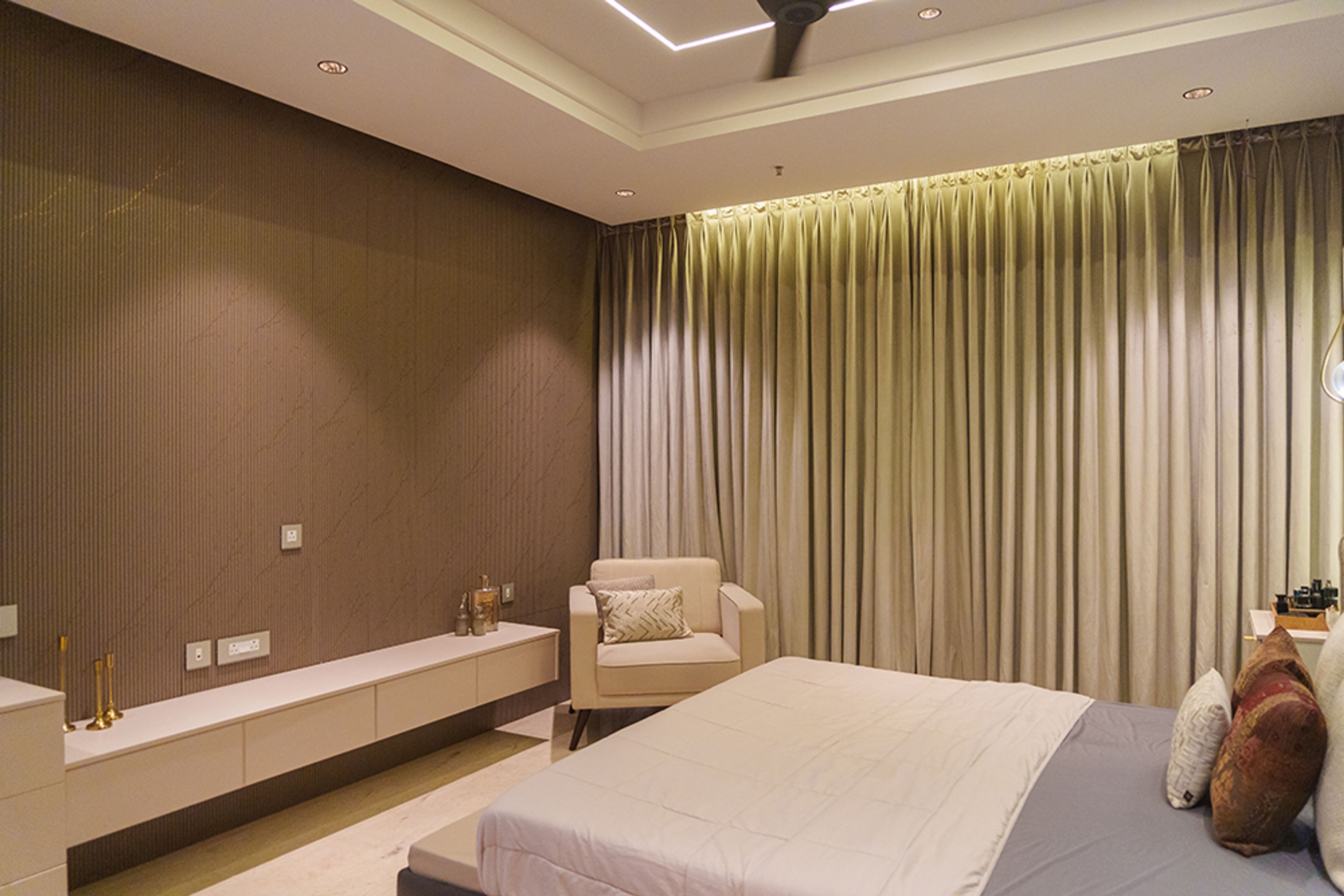 Bedroom Design with Brown Fluted Wall Panel TV Unit and Off-Whote Accent Chair