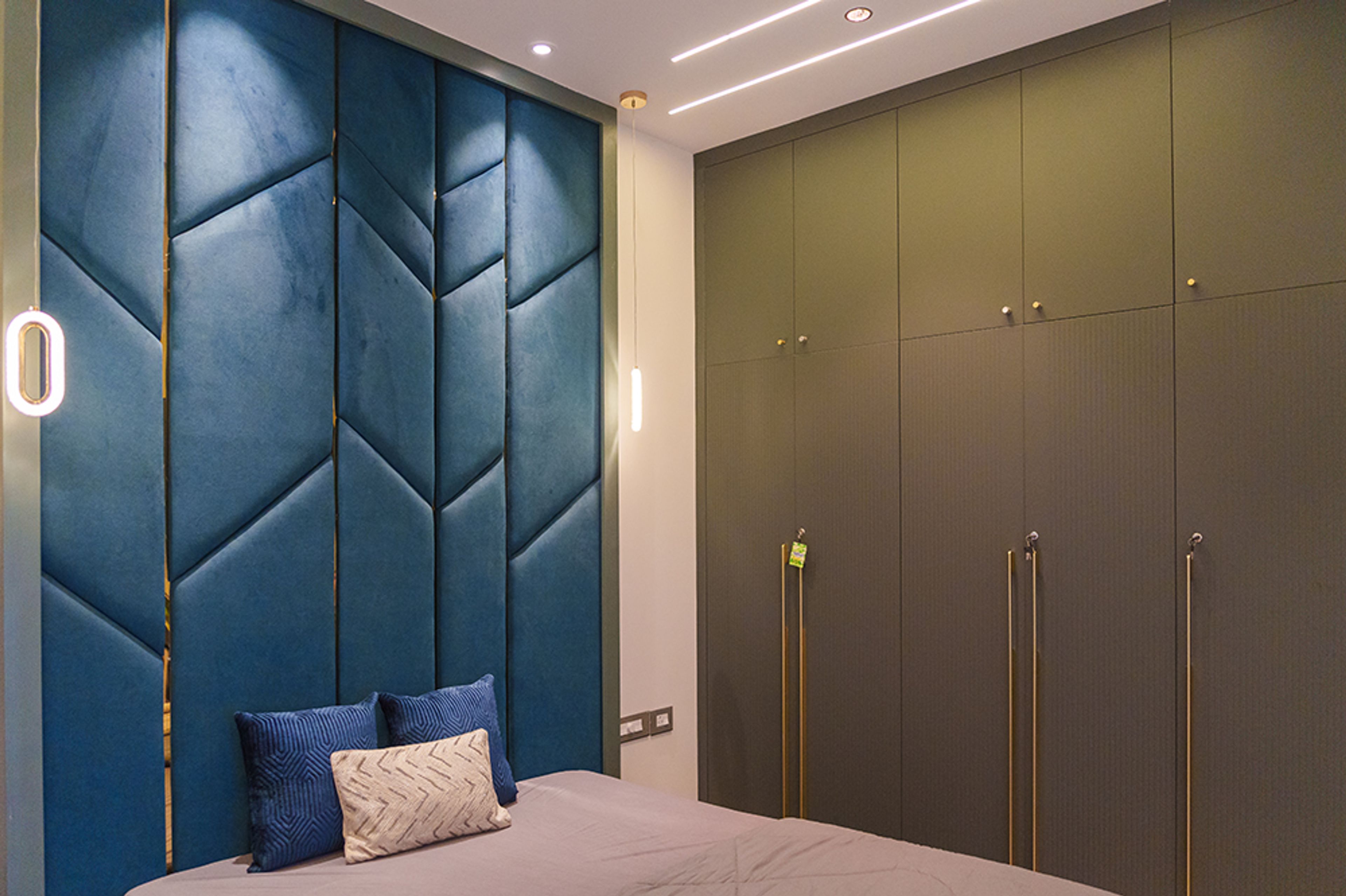 Bedroom Design with Blue Tufted Headboard Wall and Grey 5-Door Swing Wardrobe