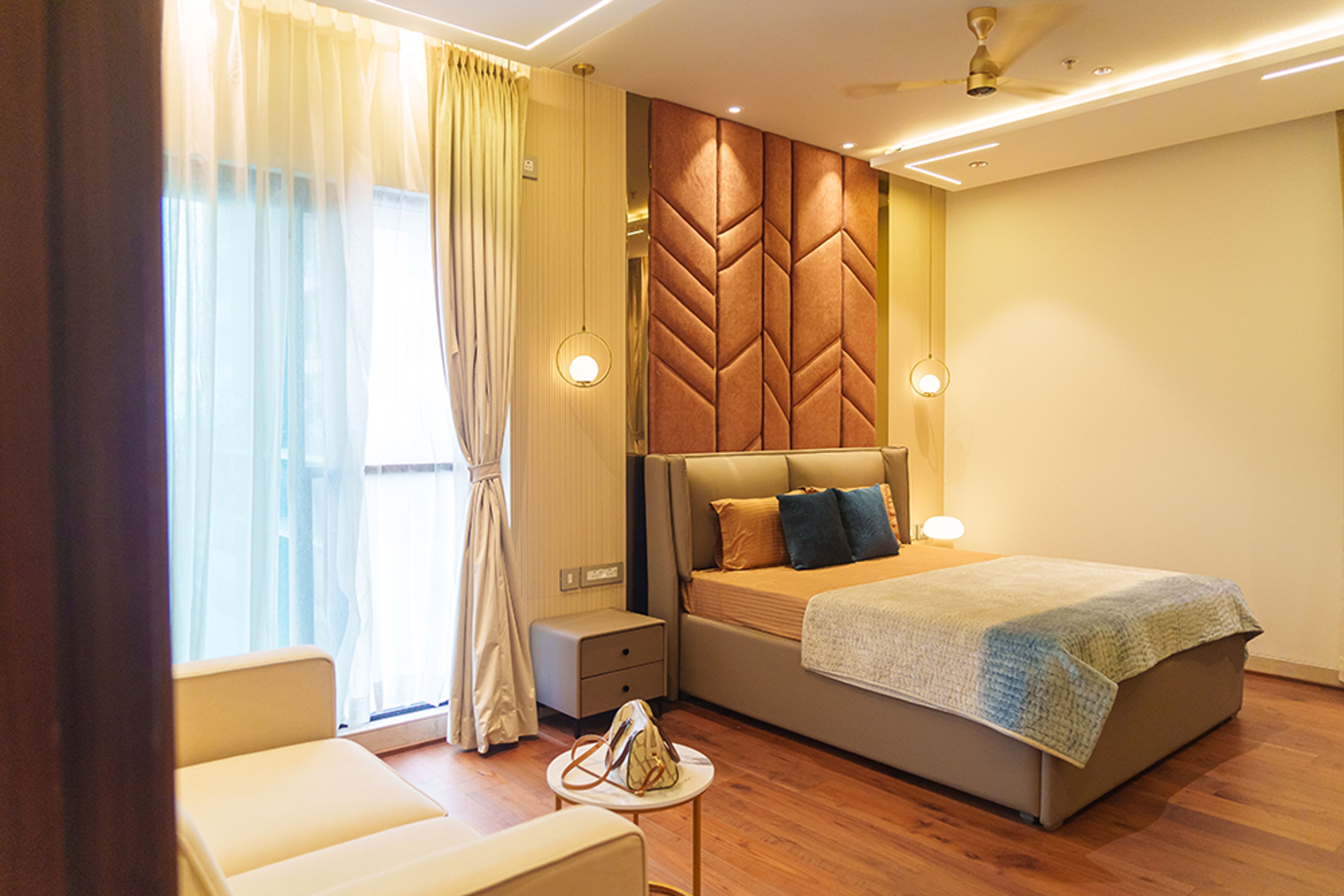 Bedroom Design with Orange Tufted Headboard Wall and Wooden Flooring