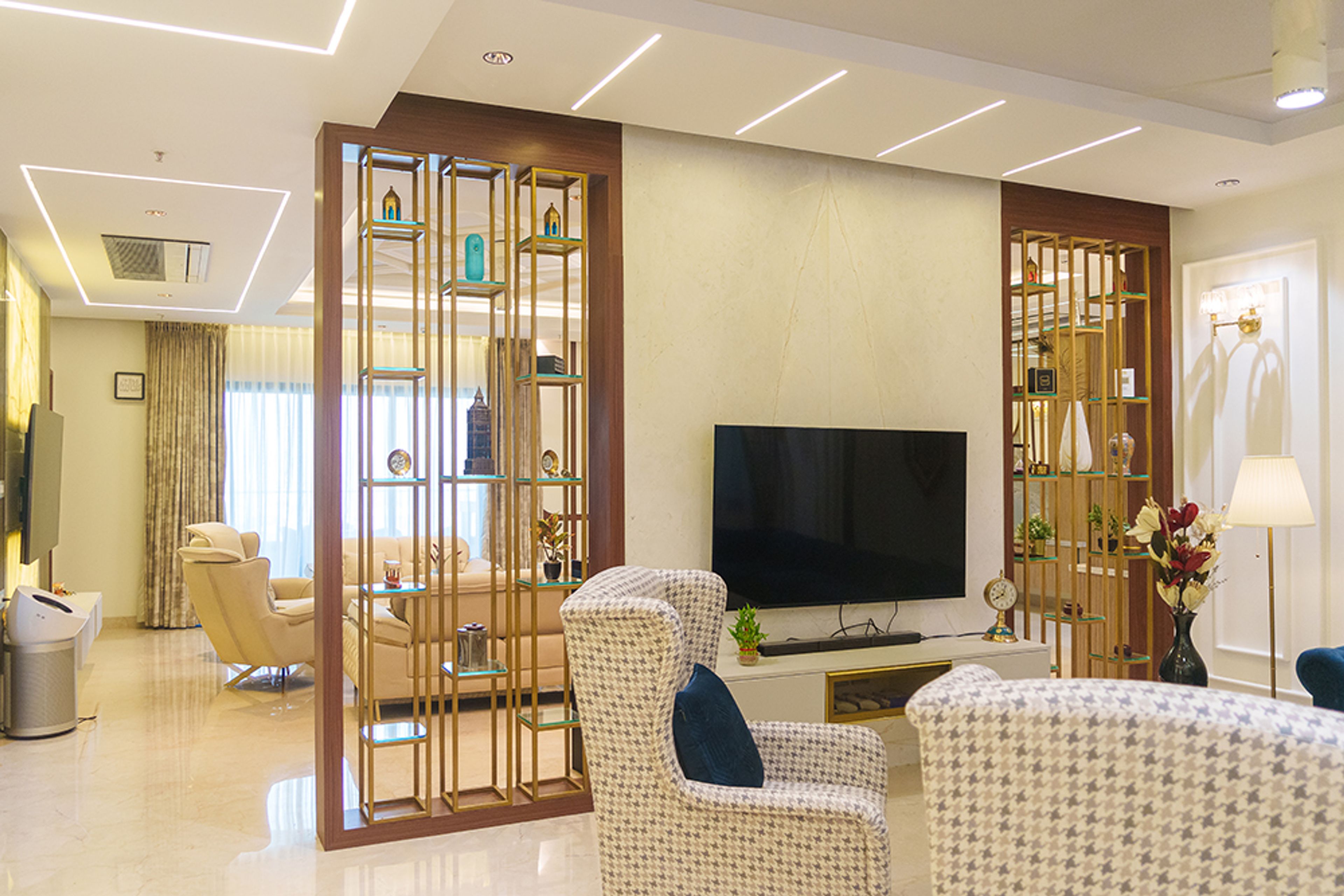 Living Room Design with Gold Framed Display Partition and TV Unit