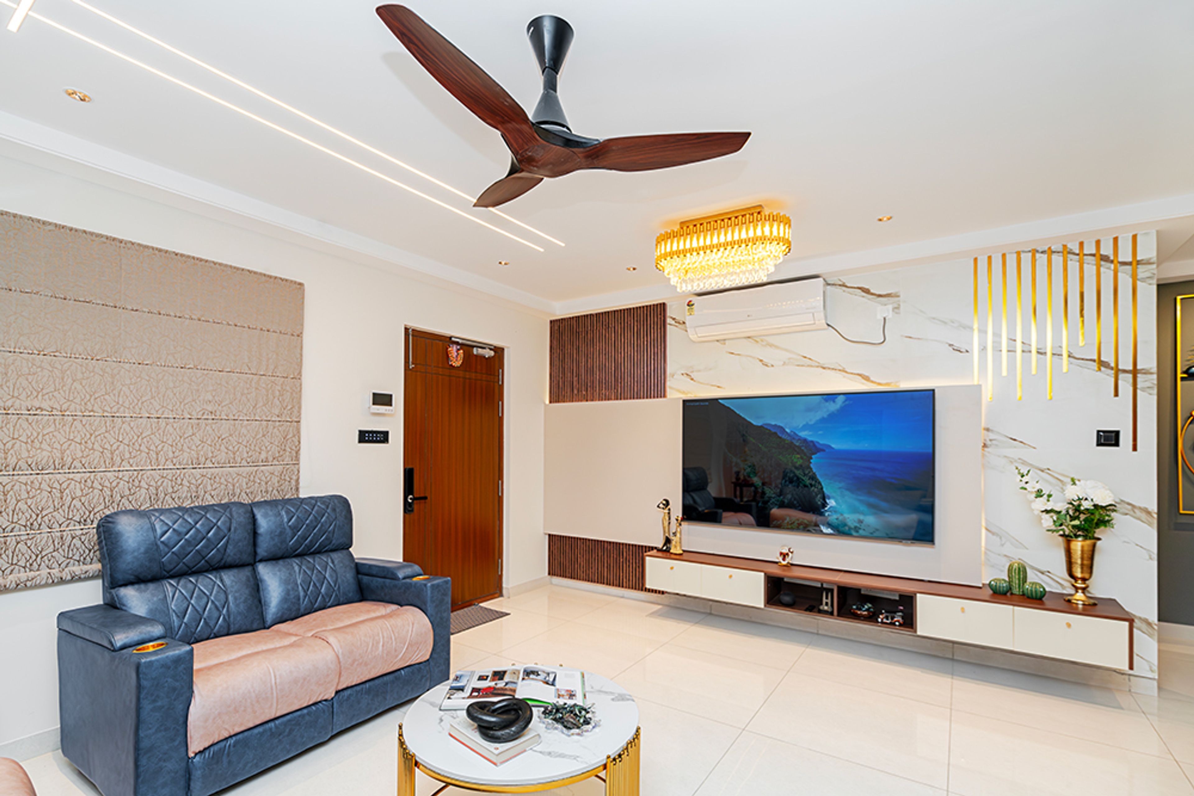 Living Room Design with Blue and Beige Sofas and White TV Unit with Marble Patterned Wall with Fluted Panels