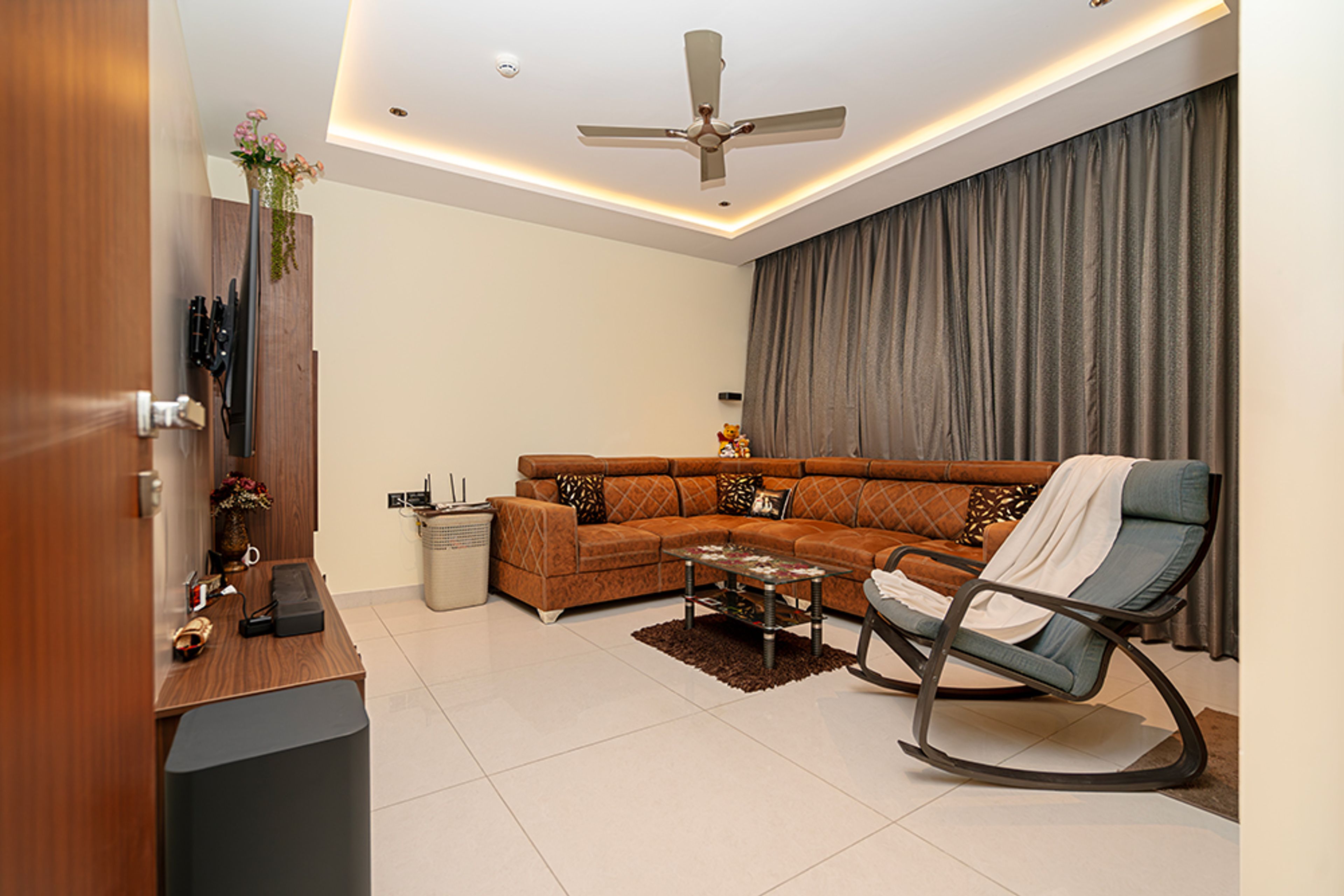 Home Office Design with Brown Leather L-Shaped Sofa and Rocking Chair