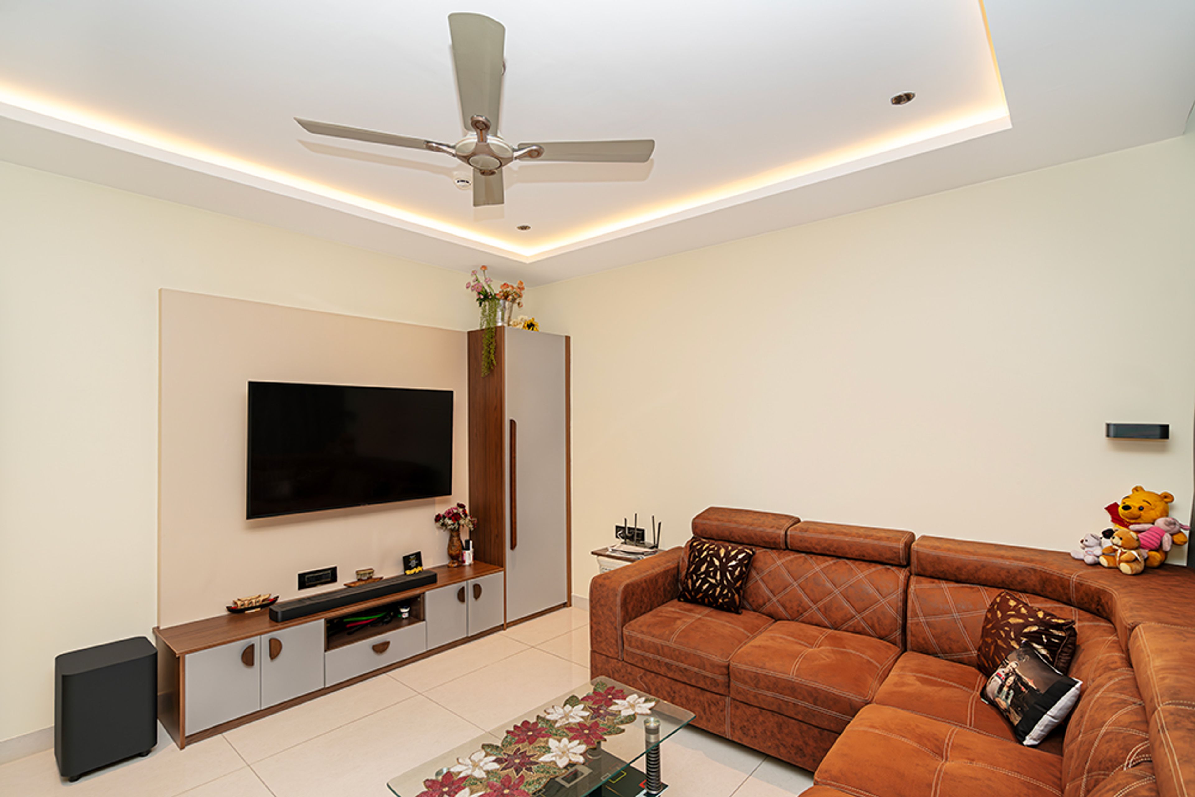 Home Office Design with Brown Leather Sofa and TV Unit with Grey and Wooden Drawers and Tall Unit