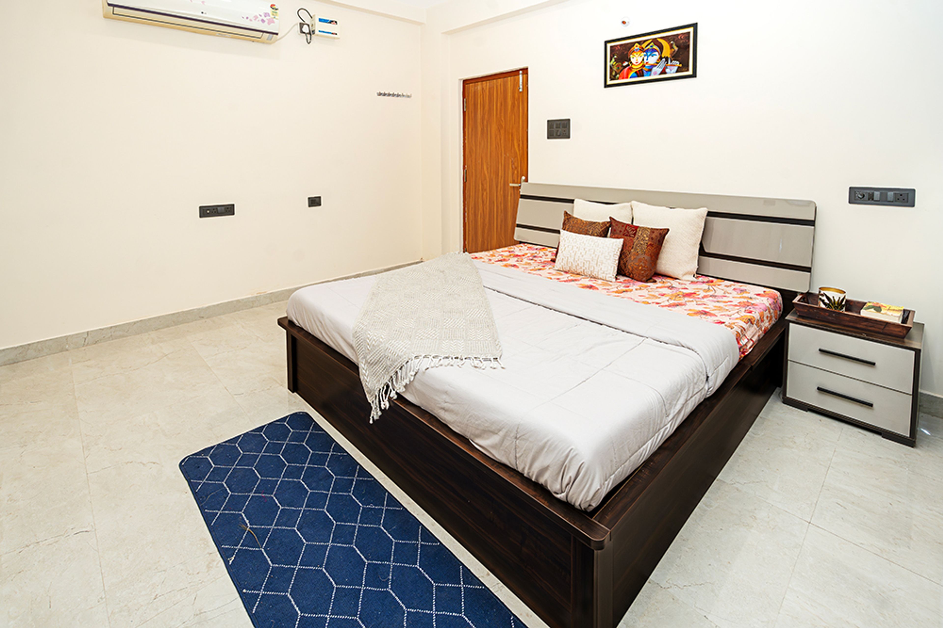 Bedroom Design with Cream Walls and Wooden Headboard