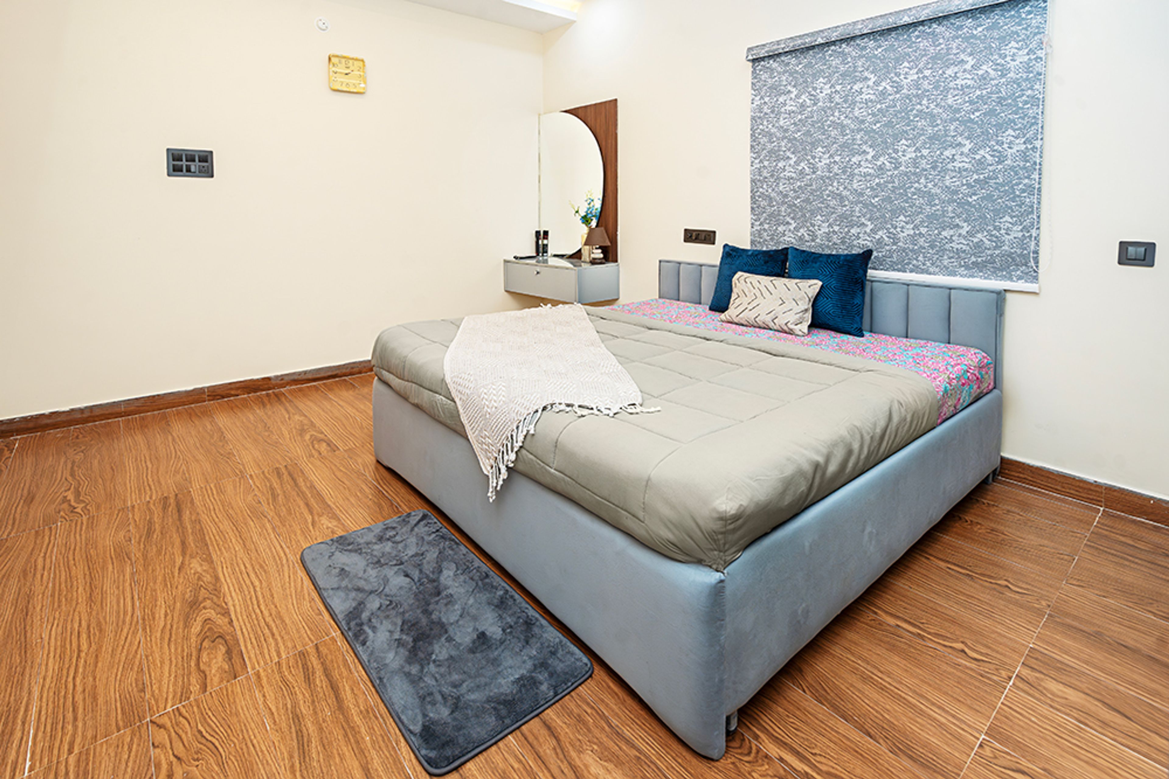 Bedroom Design with Wooden Flooring and White Walls