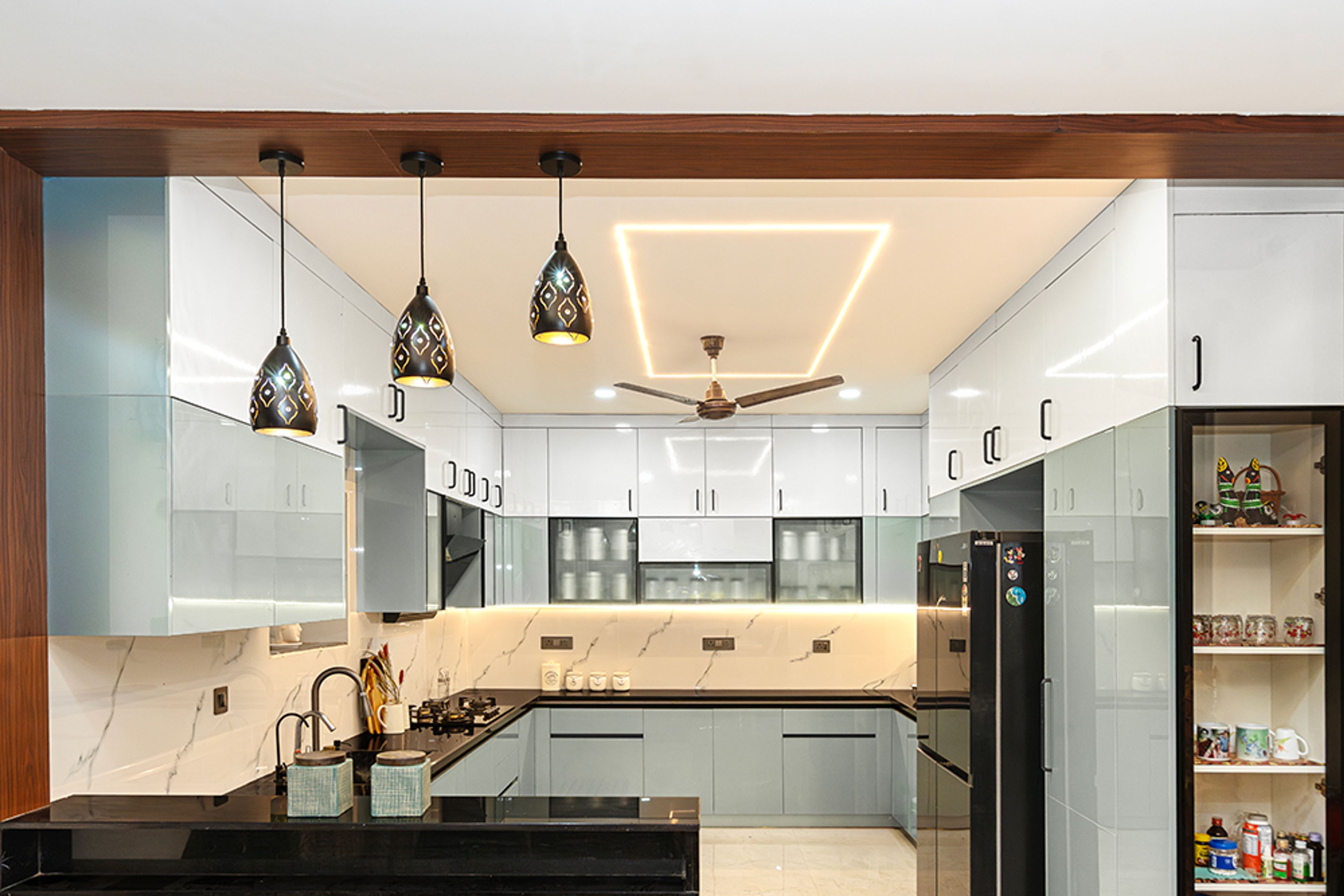 U-Shaped Kitchen Design with Geometric Gypsum Ceiling With LED Border, Central Fan, Recessed Cove Lighting