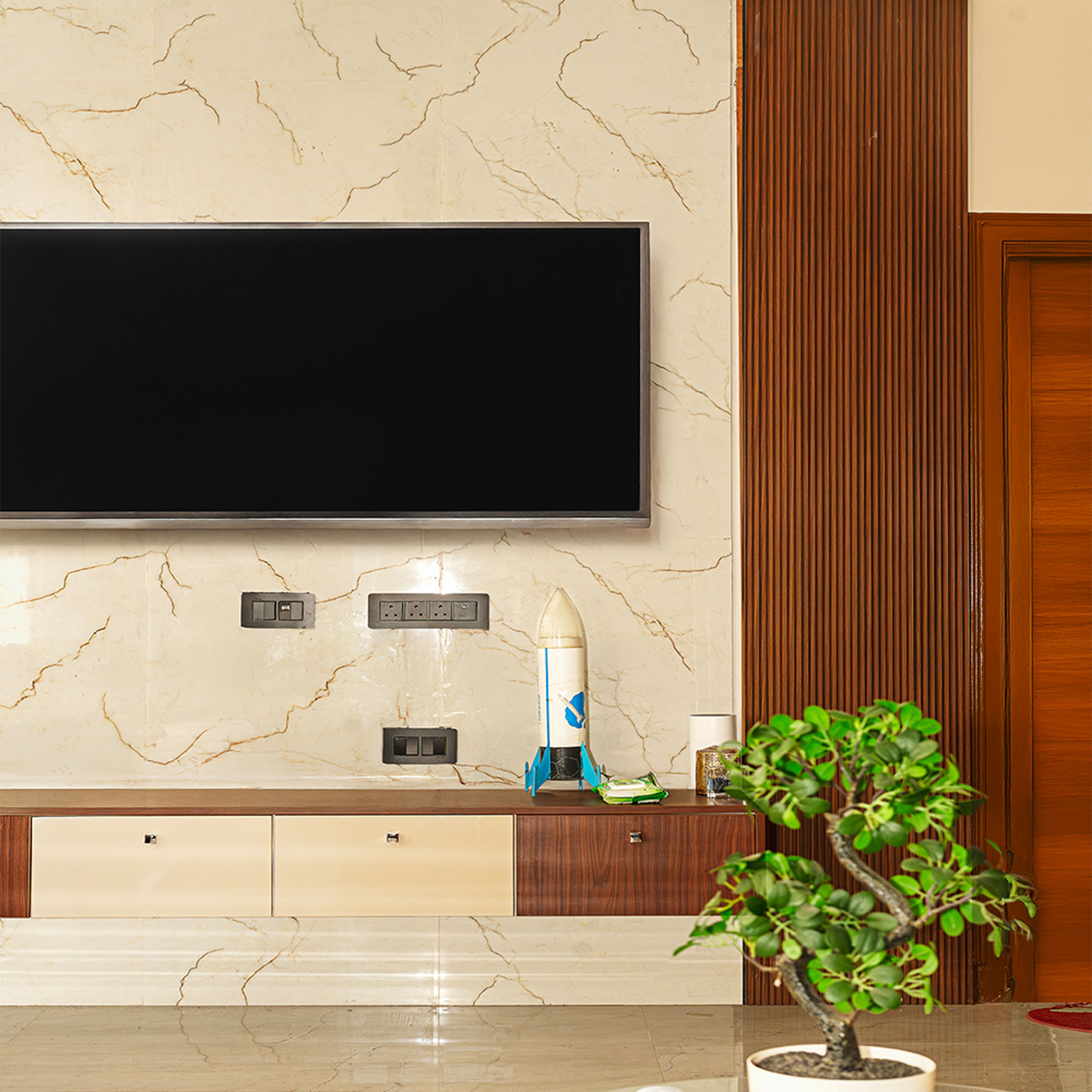 TV Unit Design with Cream Marble Textired Wall and Brown Fluted Panels