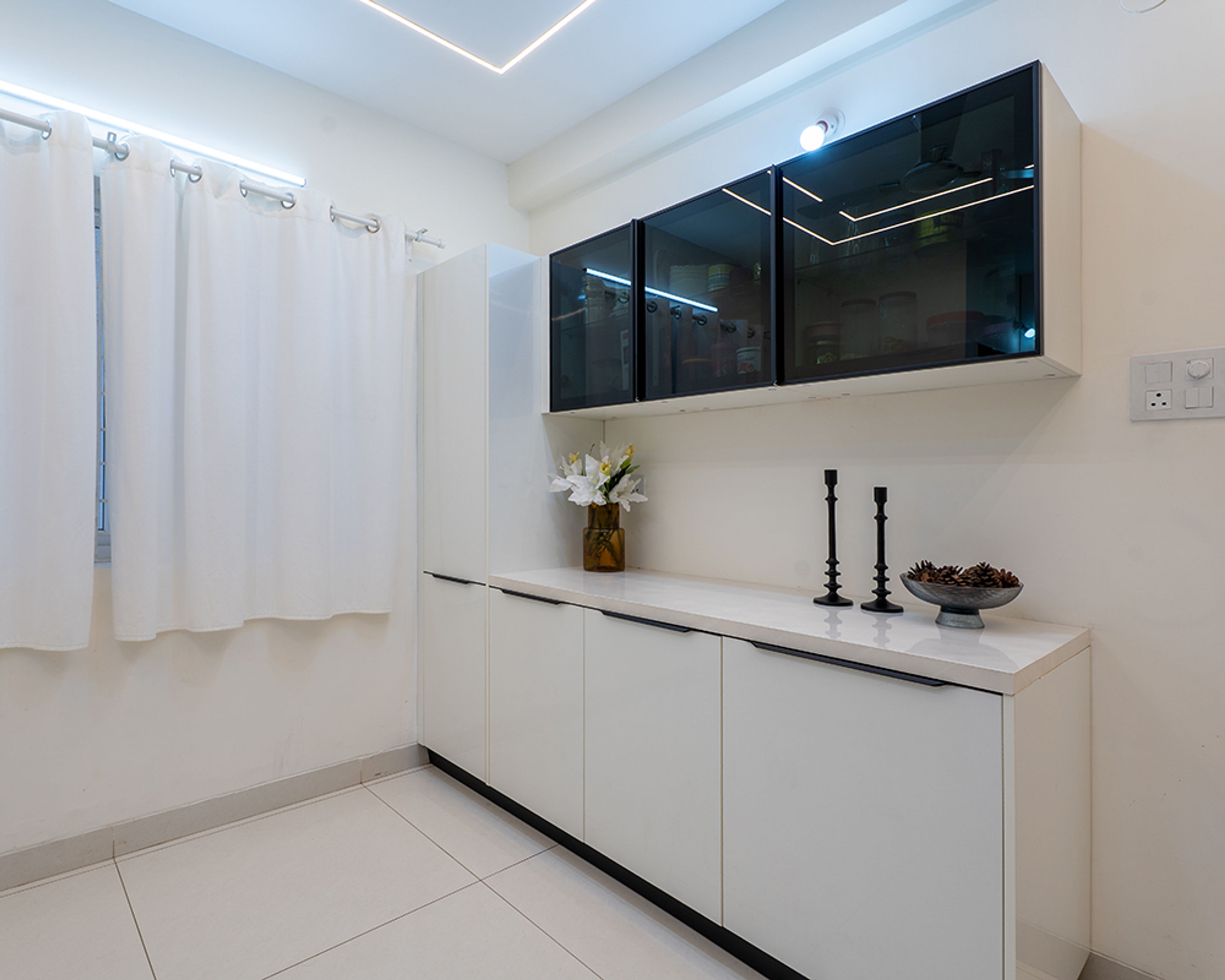 Crockery Unit Design with White Base Cabinets and Black Glass Upper Cabinets